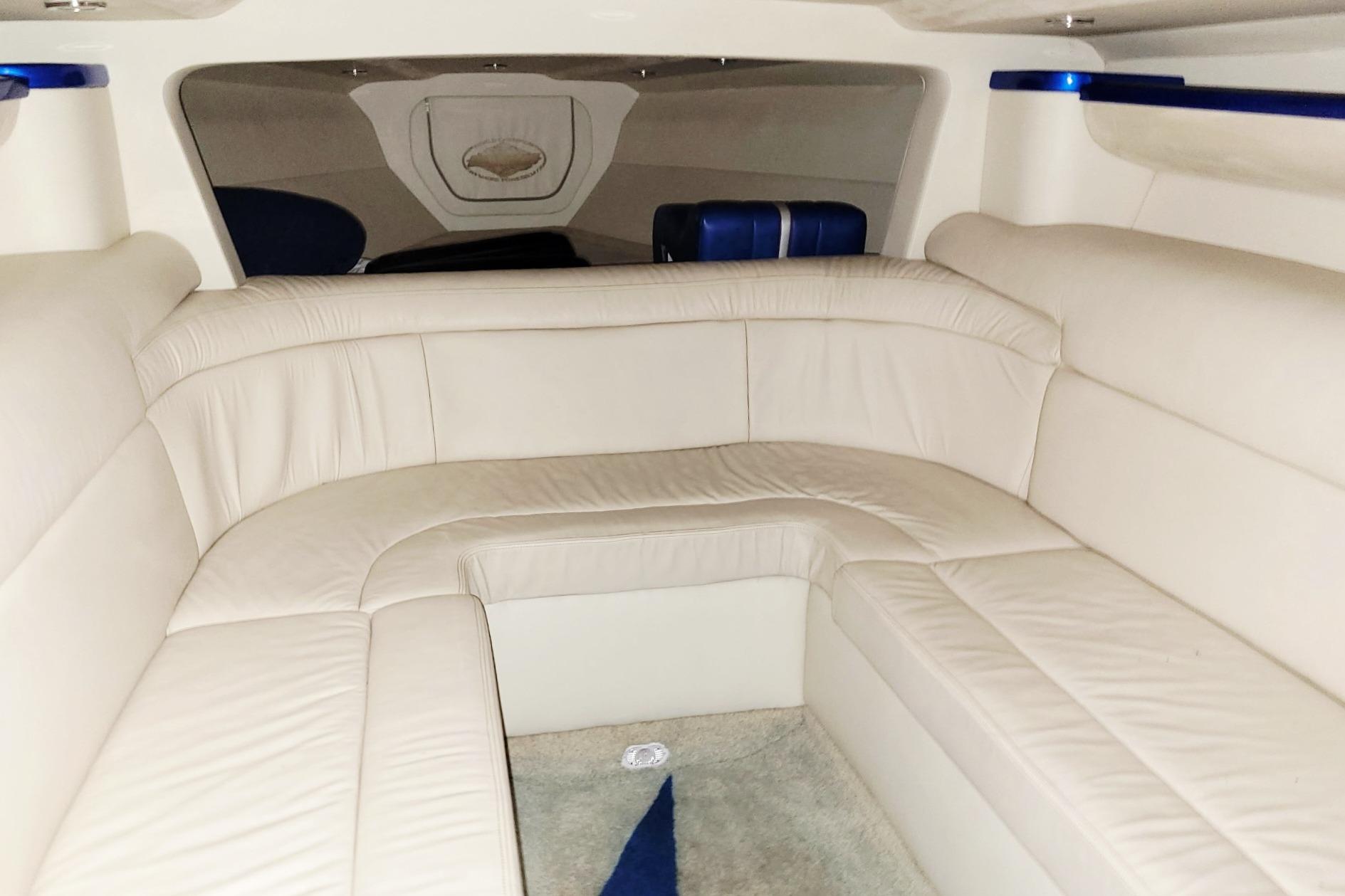 Interior of a 2004 Outerlimits 42 Legacy boat with white leather seating.