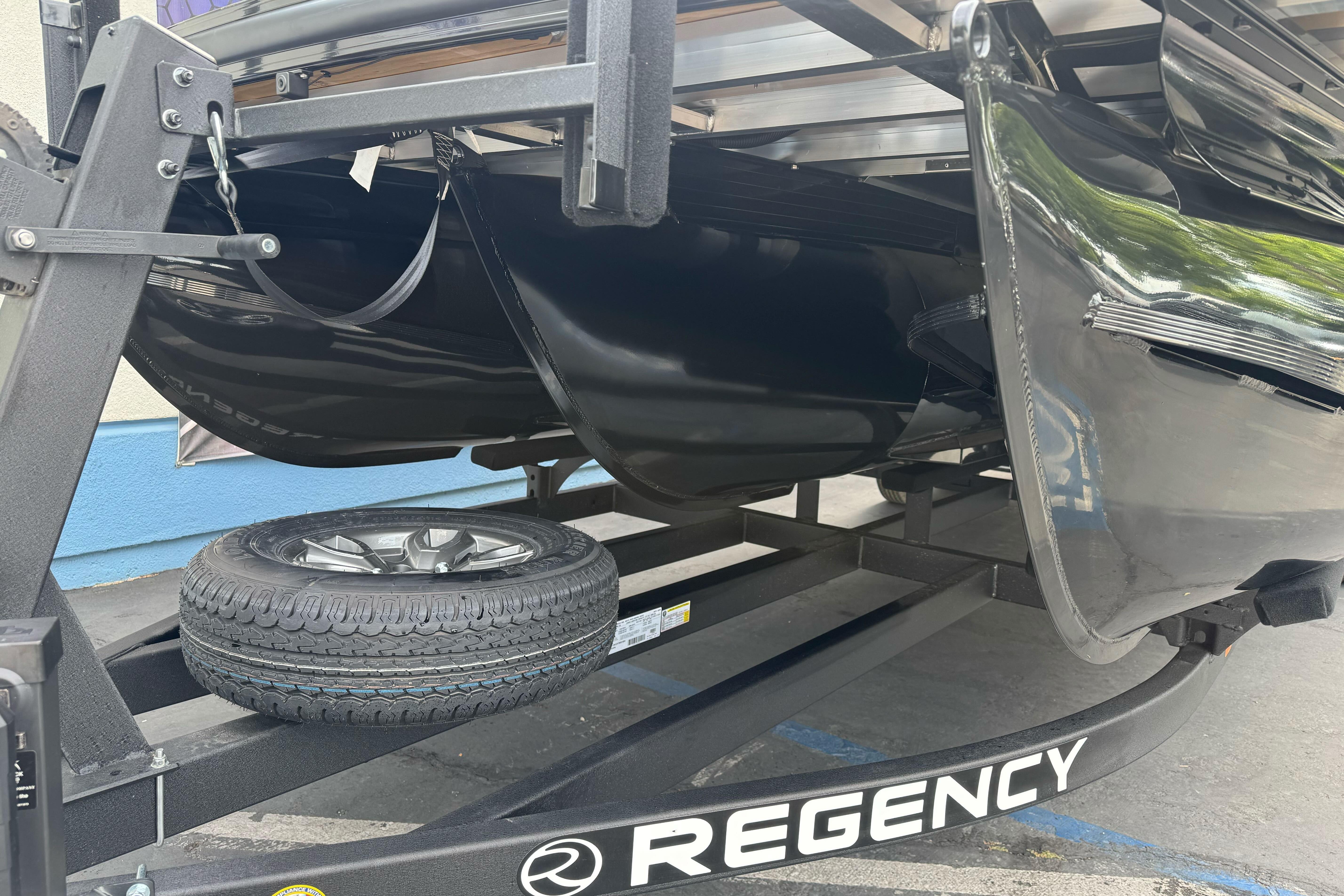 2026 Regency 250 DL boat trailer with spare tire, showcasing sleek black design.