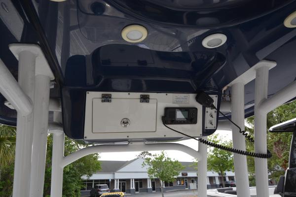 2021 Sea Pro 228 Bay boat console with radio and storage compartment.