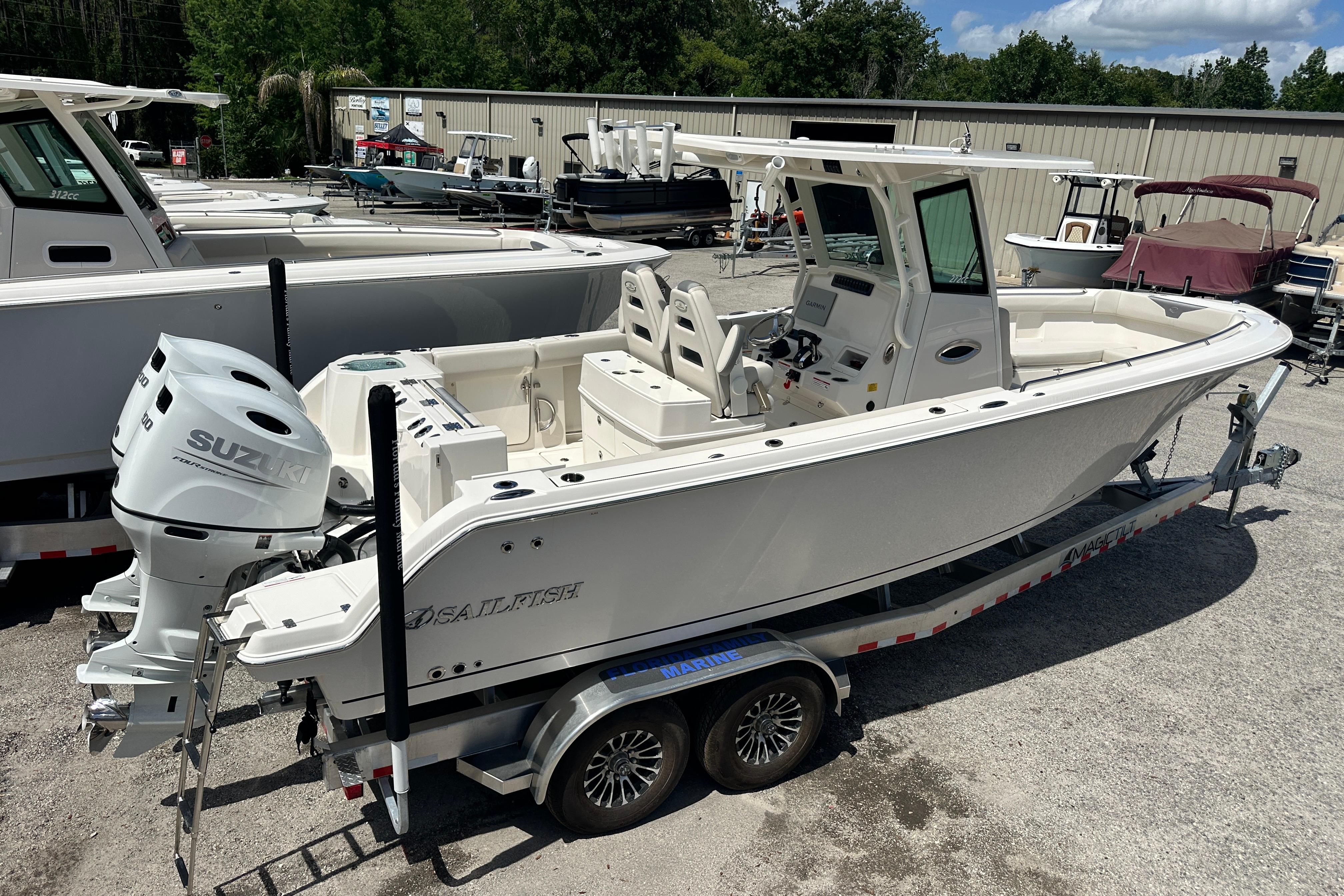 2026 Sailfish 272 CC boat on trailer with dual Suzuki outboard motors.