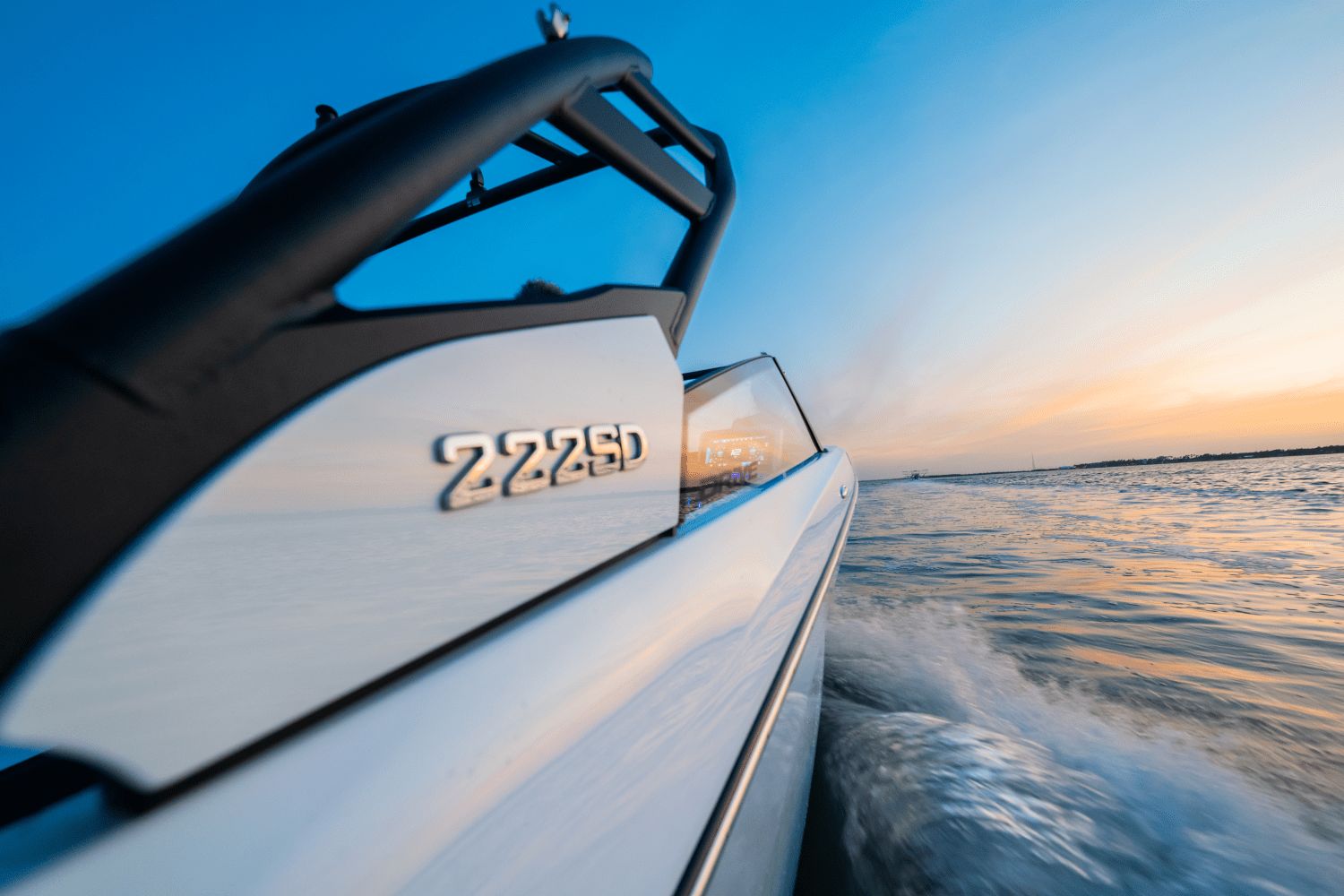 Yamaha 222SD boat speeding across the water at sunset.