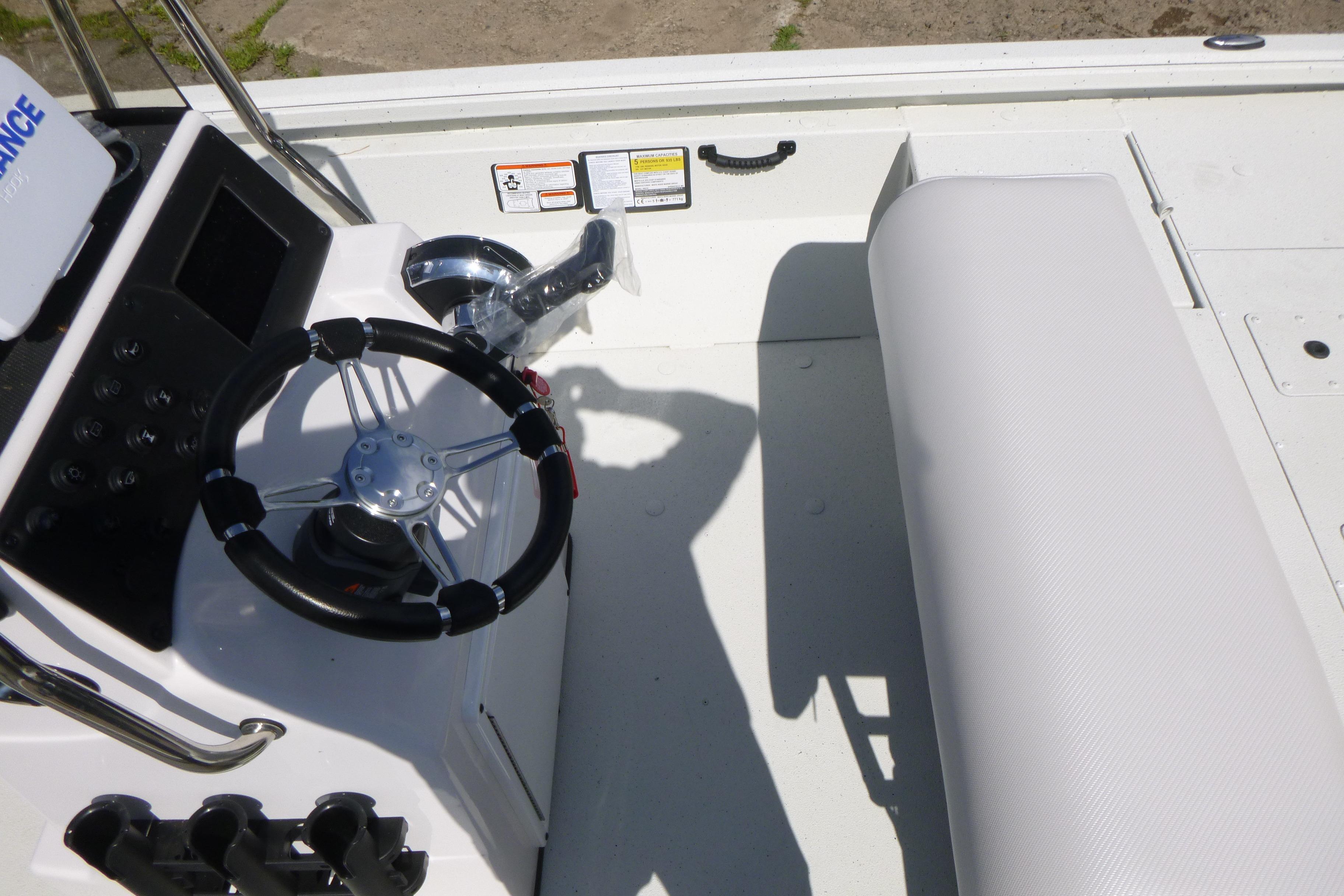 2025 Ranger RB210 boat interior with steering wheel and seating area.