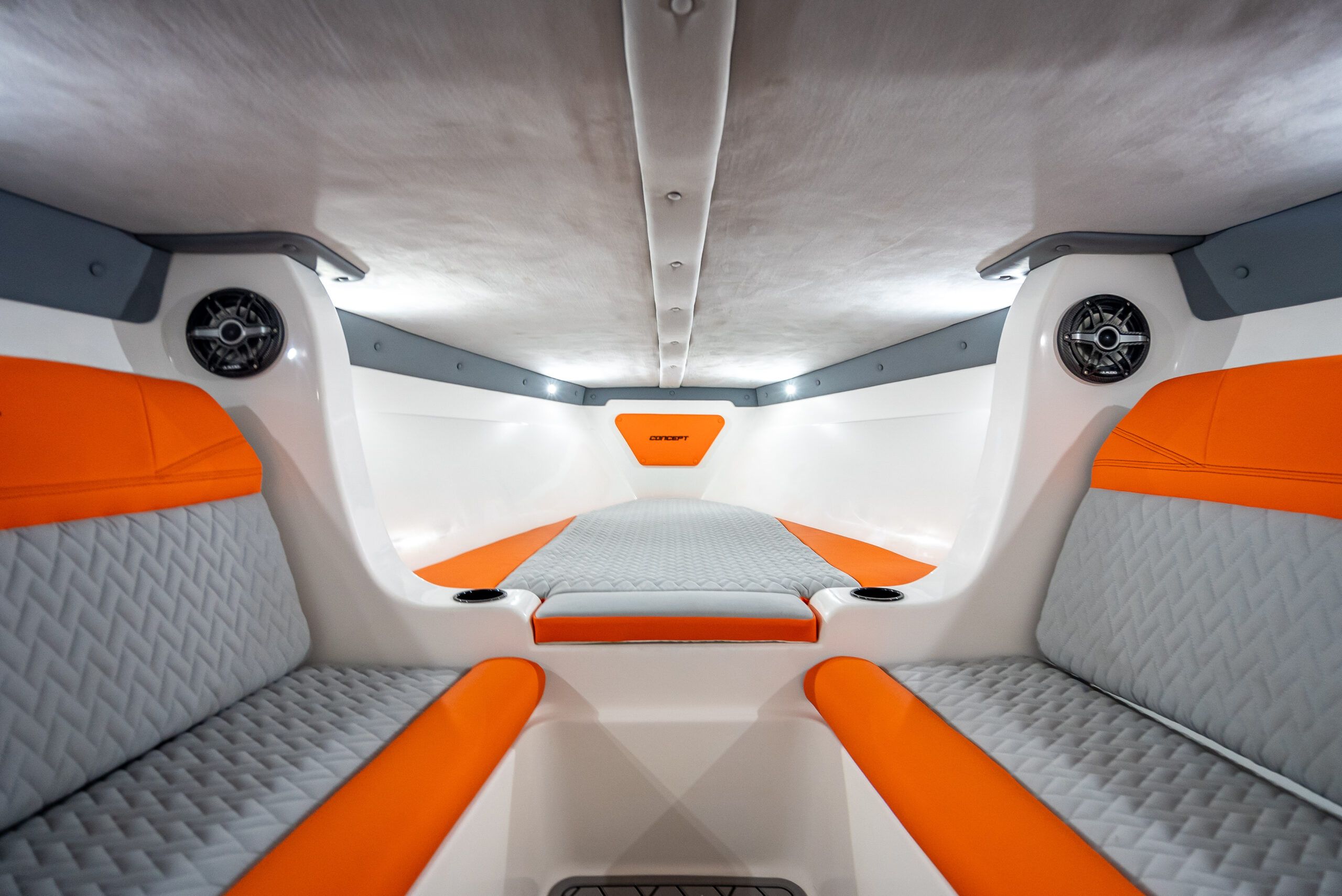Interior of a modern boat with orange and gray upholstery.