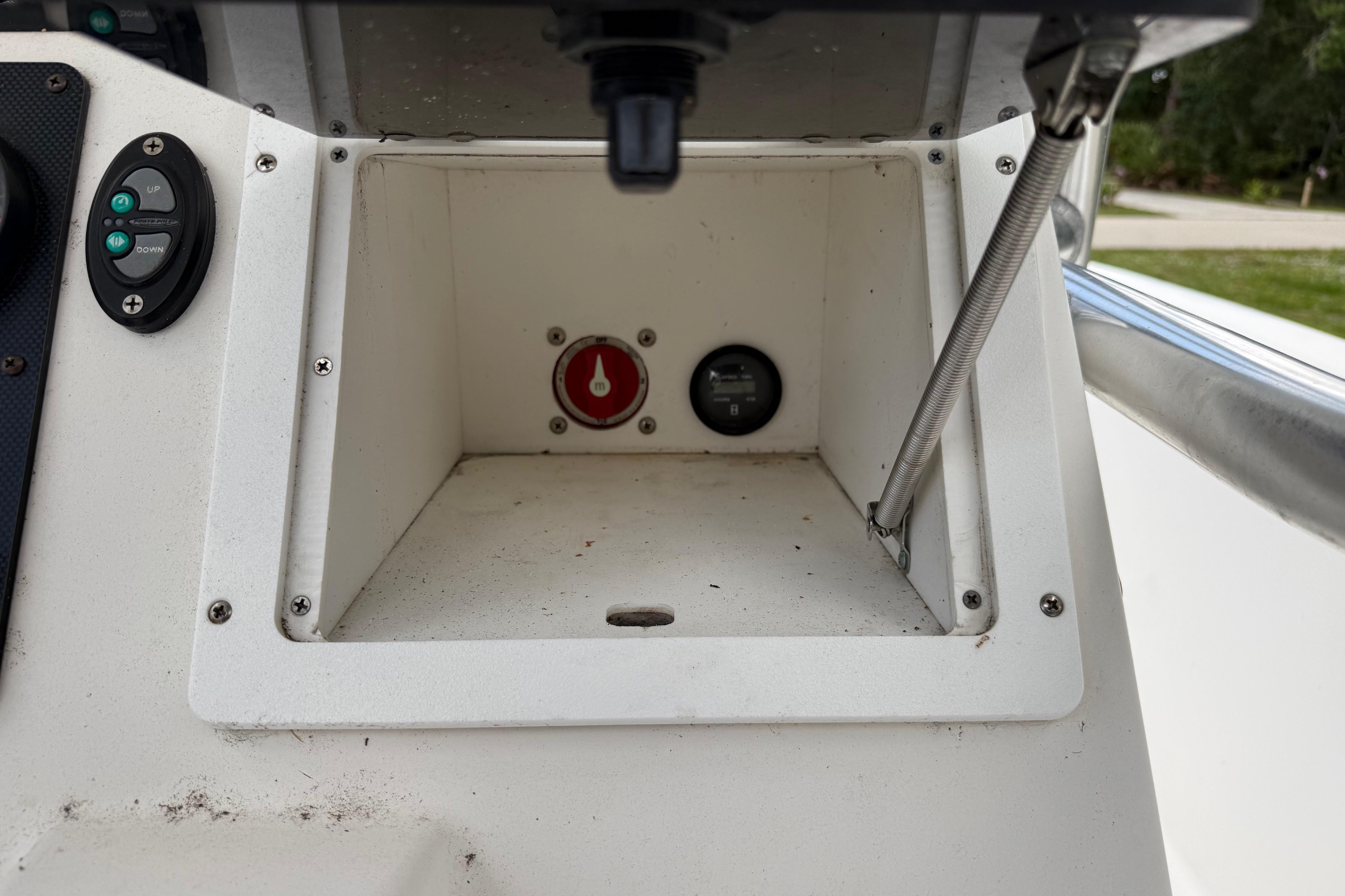 Console compartment of 2012 Clearwater 2000 Center Console boat with control buttons.