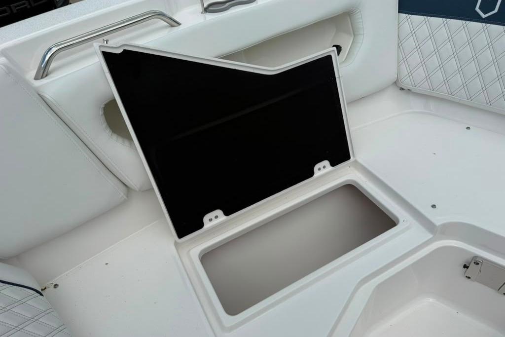 Storage compartment on a 2026 Sea Fox 288 Traveler boat, featuring white cushioned seating.