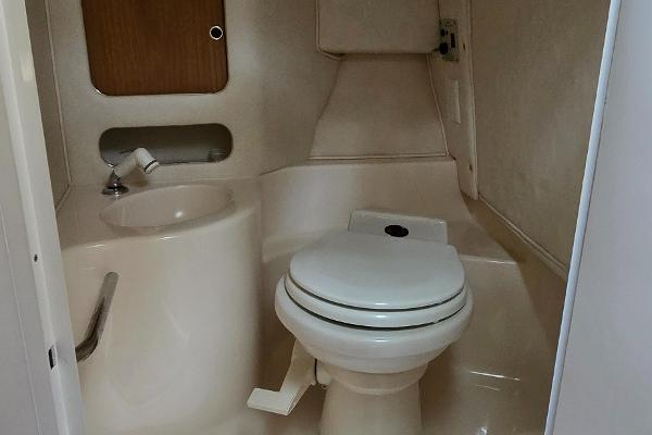 1999 Sea Ray 280 SS boat bathroom with toilet and sink.