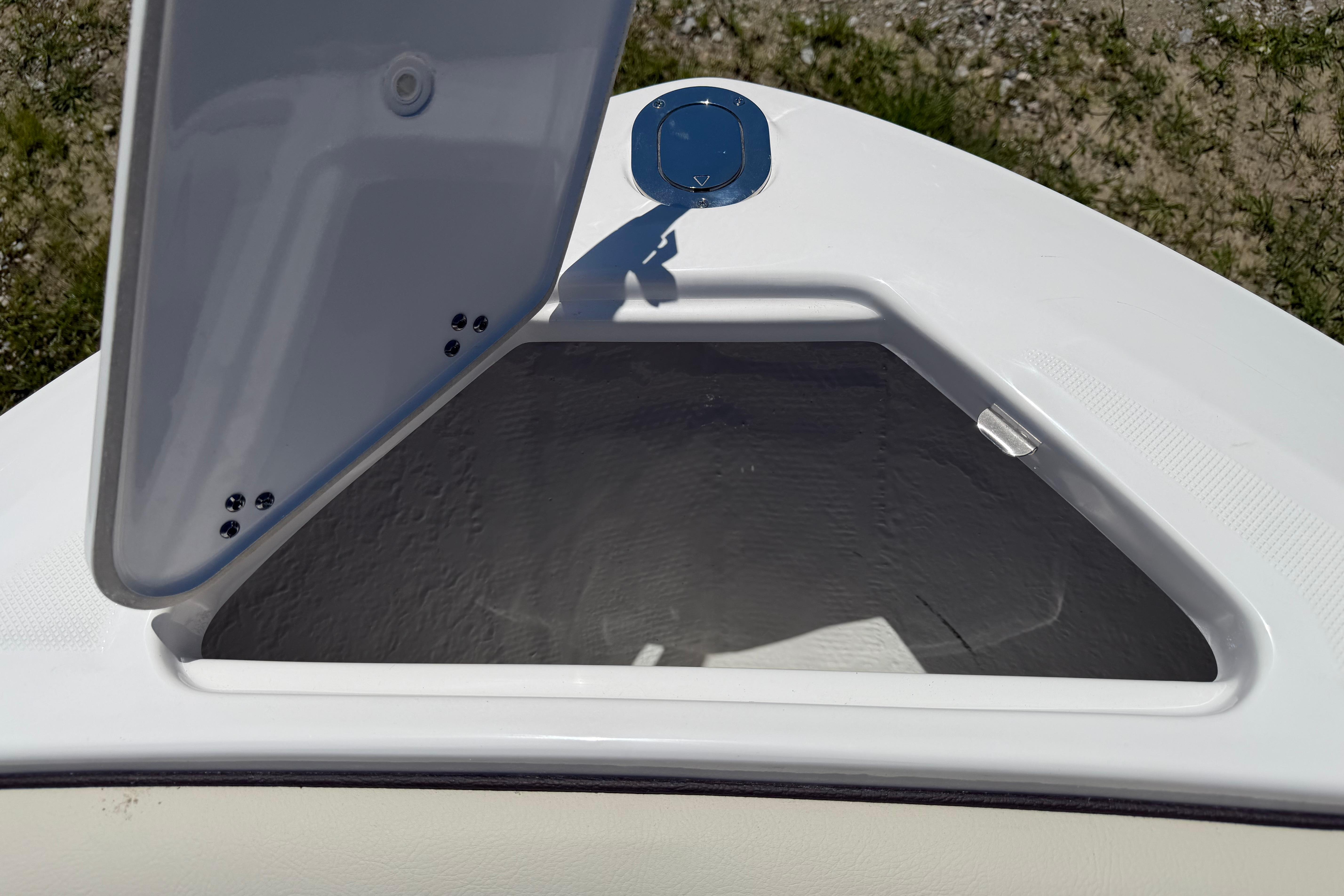 Open storage compartment on 2026 Regal LS4 boat, showcasing interior space.