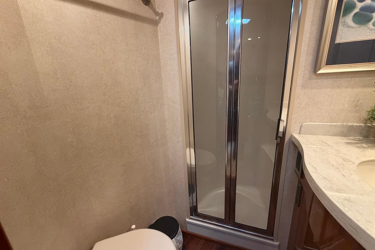 Bathroom interior of 2012 Viking 50 Convertible yacht with shower and toilet.