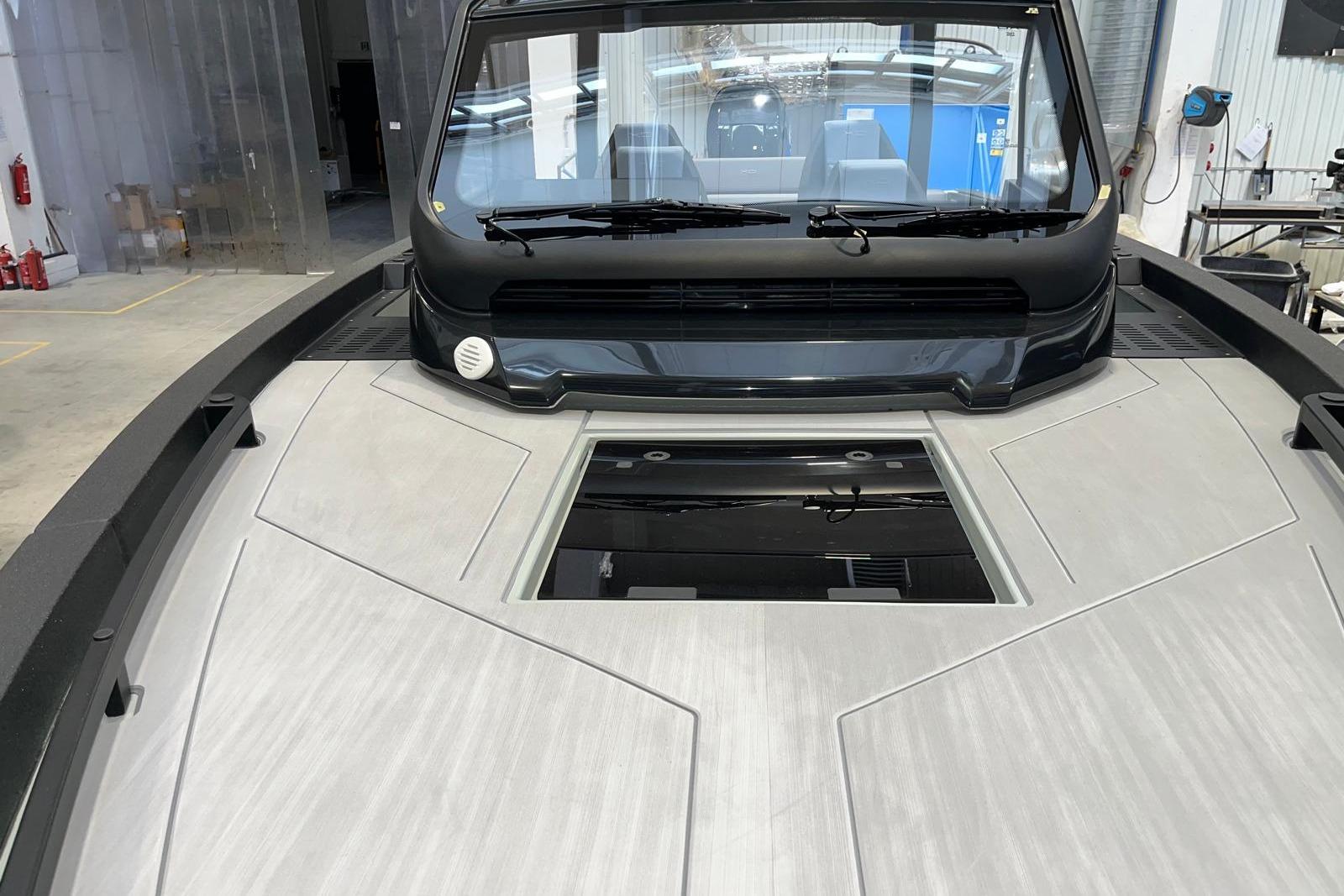 2026 XO DFNDR A8 boat interior with sleek design and modern features in a workshop setting.