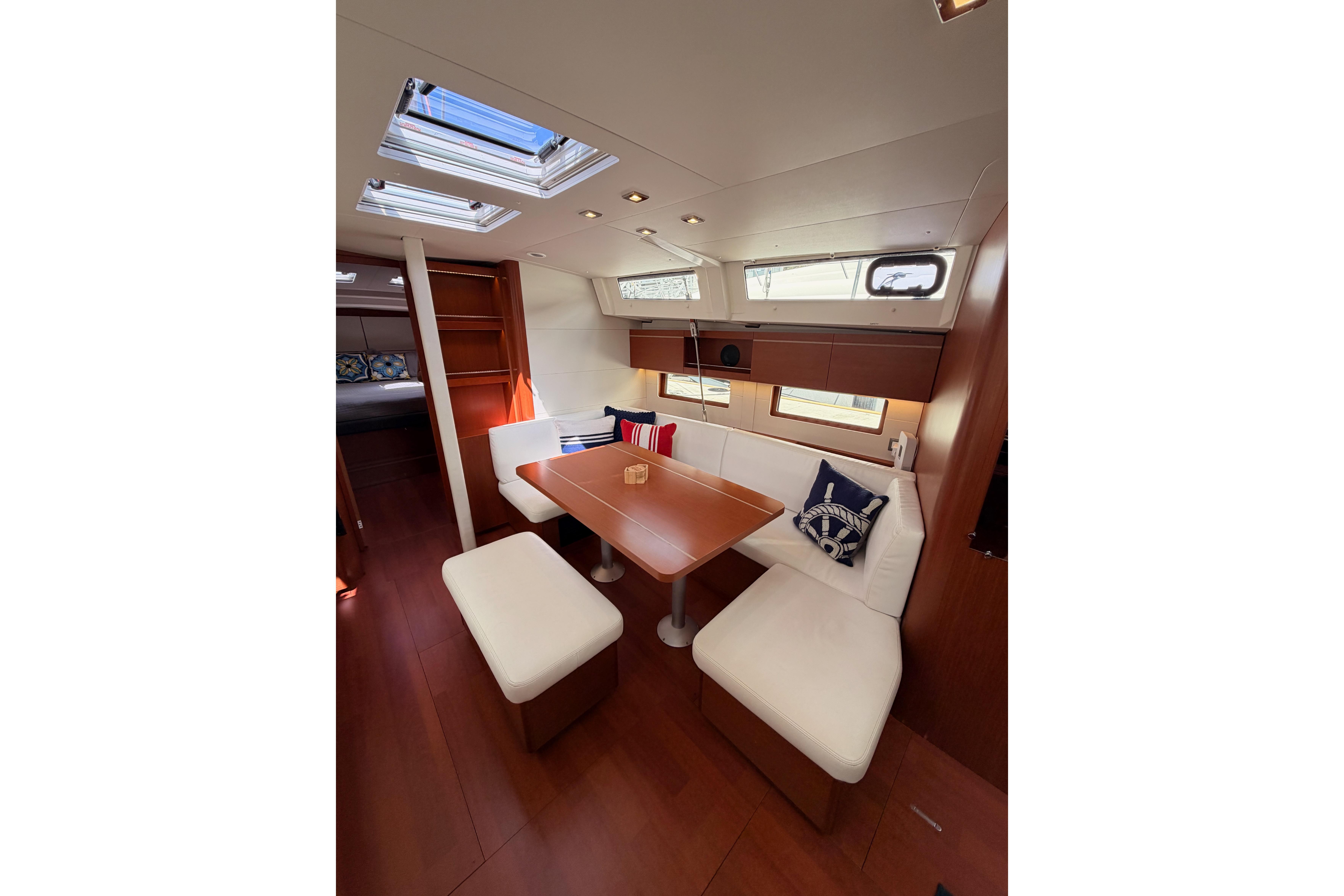 Interior of 2020 Beneteau Oceanis 46.1 yacht, featuring elegant dining area with skylights.