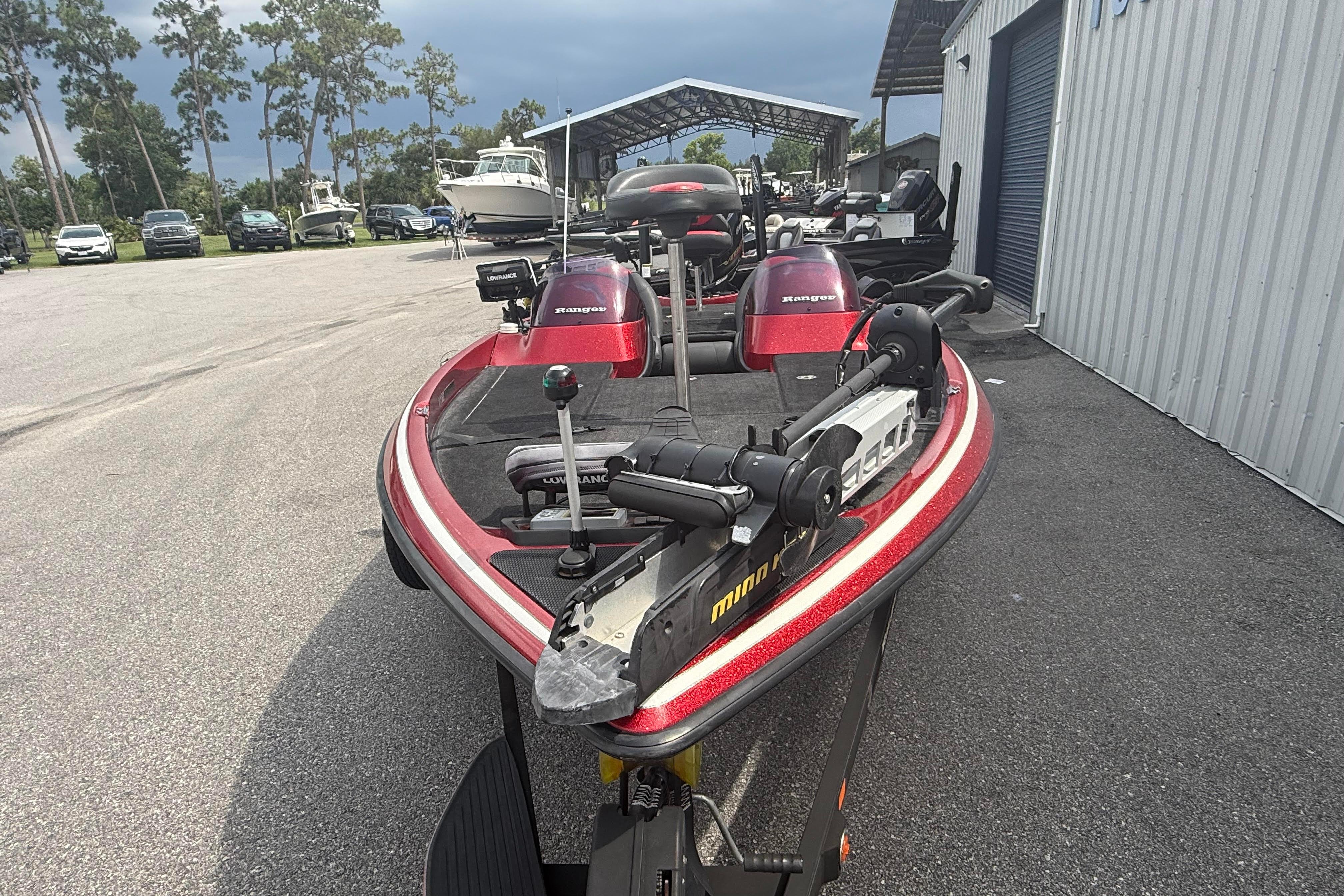 2007 Ranger 519 VX boat with red detailing, parked outdoors near a storage facility.