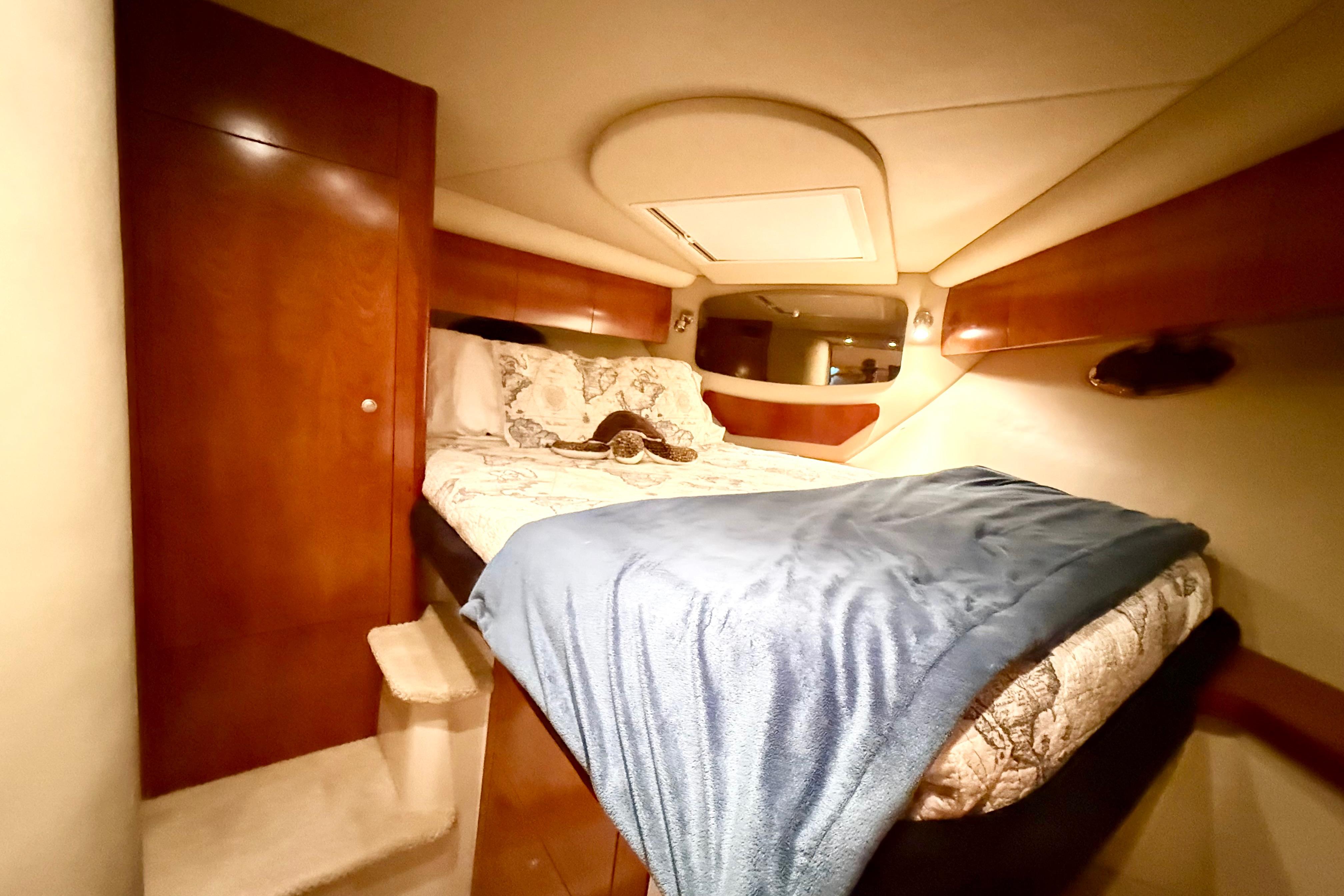 Luxurious cabin interior of 2011 Cruisers Yachts 390 Sports Coupe with cozy bedding.