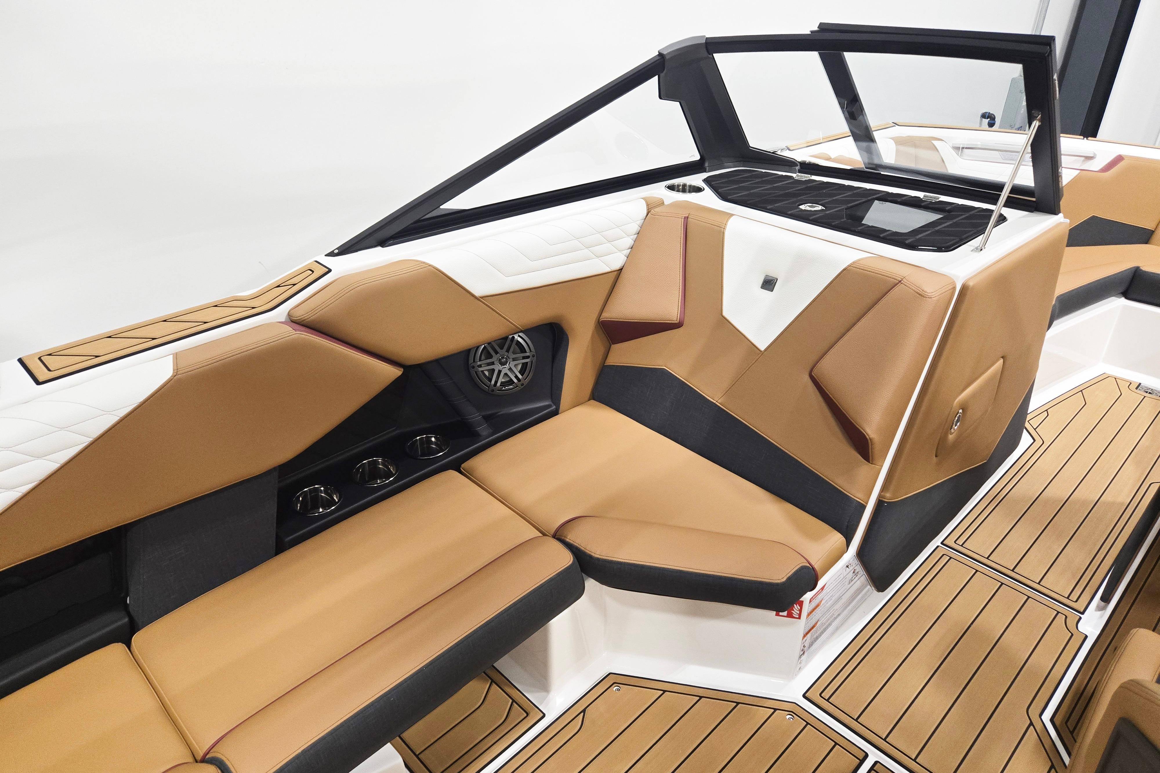 Luxurious interior of 2026 Nautique Super Air Nautique S23 boat with tan seating.