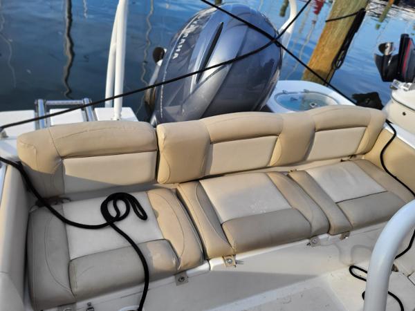 2021 NauticStar 2302 Legacy boat with cushioned seating and Yamaha outboard motor.