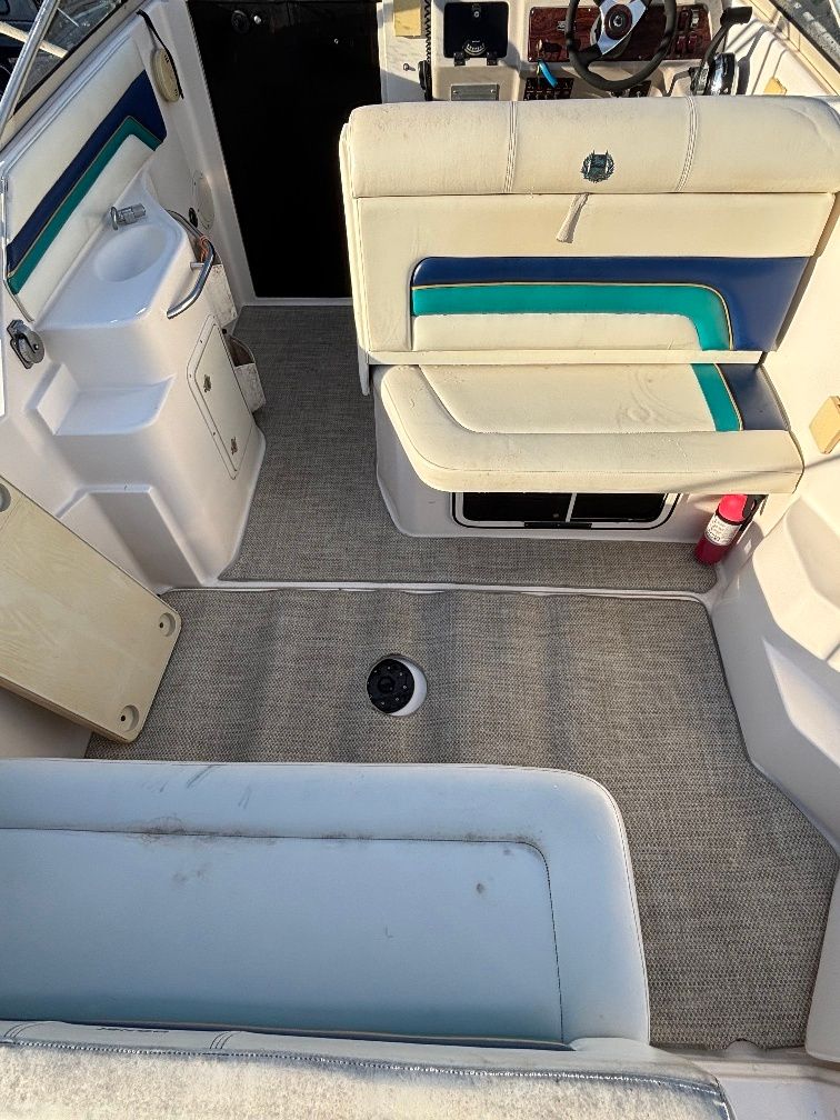 Interior of a 1997 Donzi 275LXC boat with seating and sink.