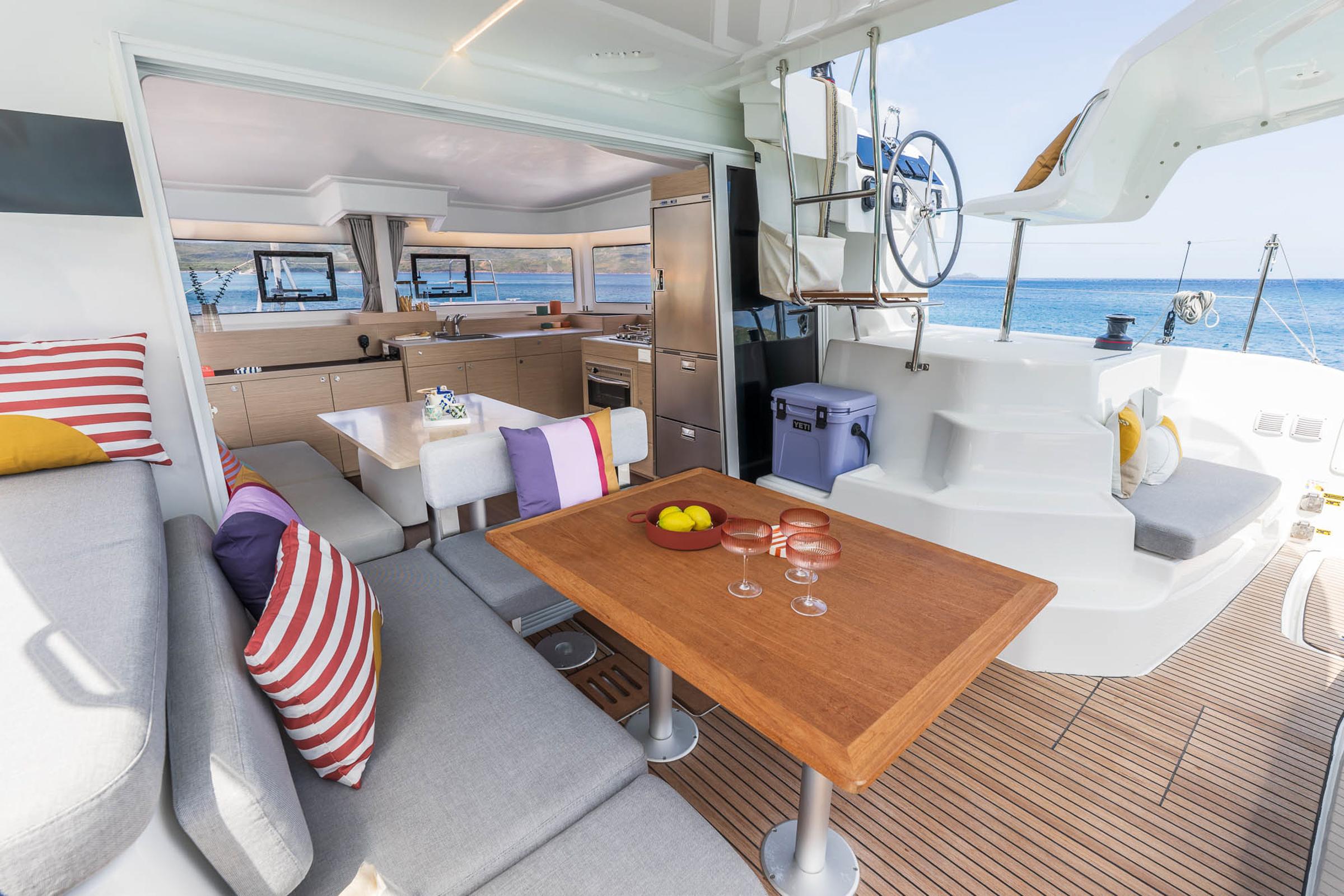 Luxurious 2025 Lagoon 38 yacht interior with modern kitchen and seating area.