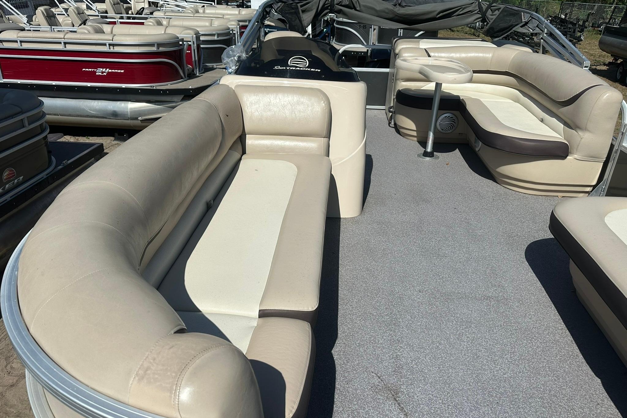 2016 SUNTRACKER Party Barge 20 pontoon boat with beige seating and spacious deck layout.