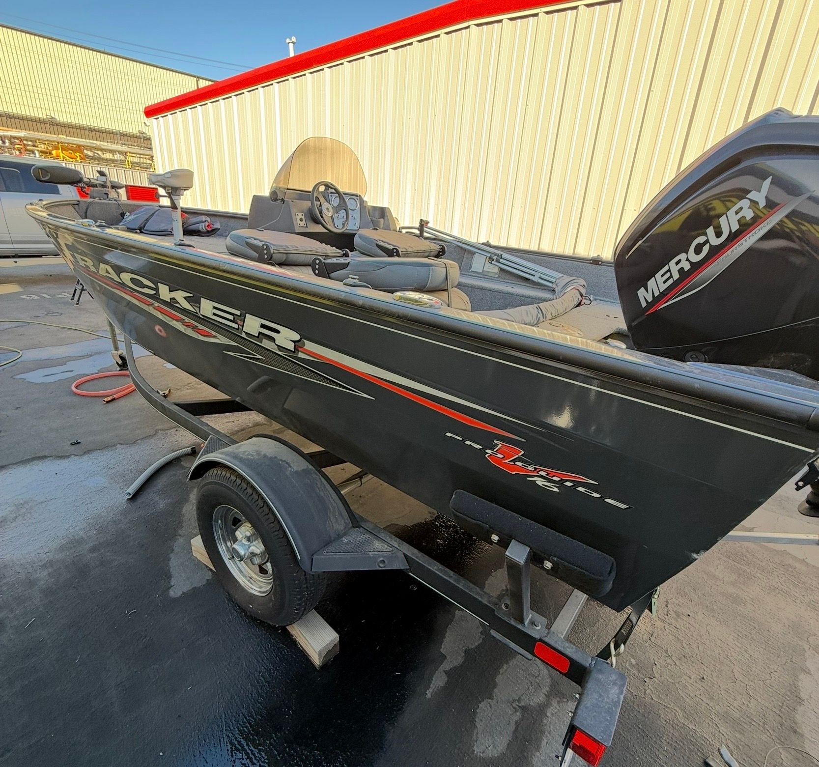 A 2021 Bass Tracker Pro Guide V 16 on a trailer, featuring a Mercury engine.