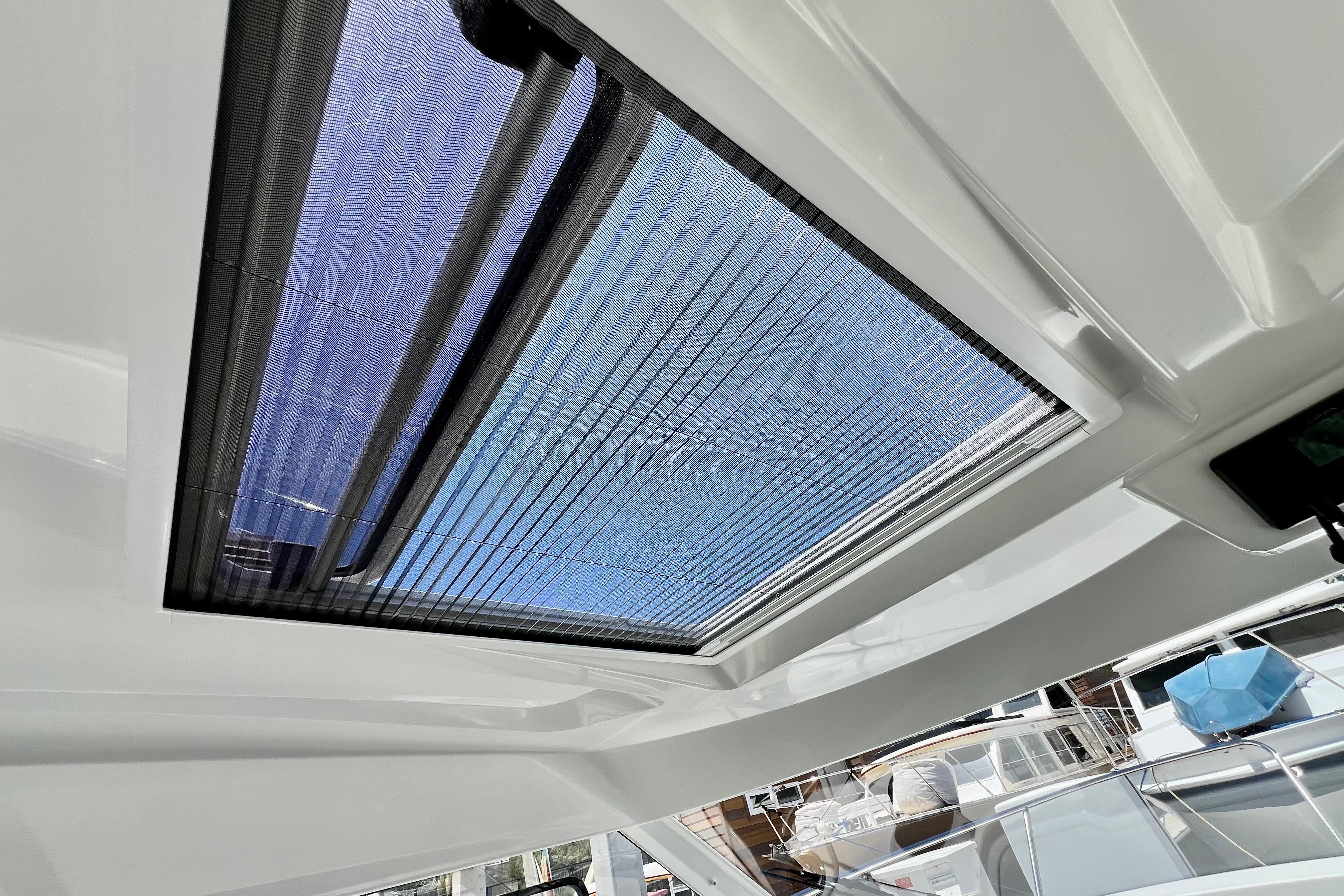 2023 Beneteau Antares 8 boat interior with sunroof, showcasing modern design and natural light.