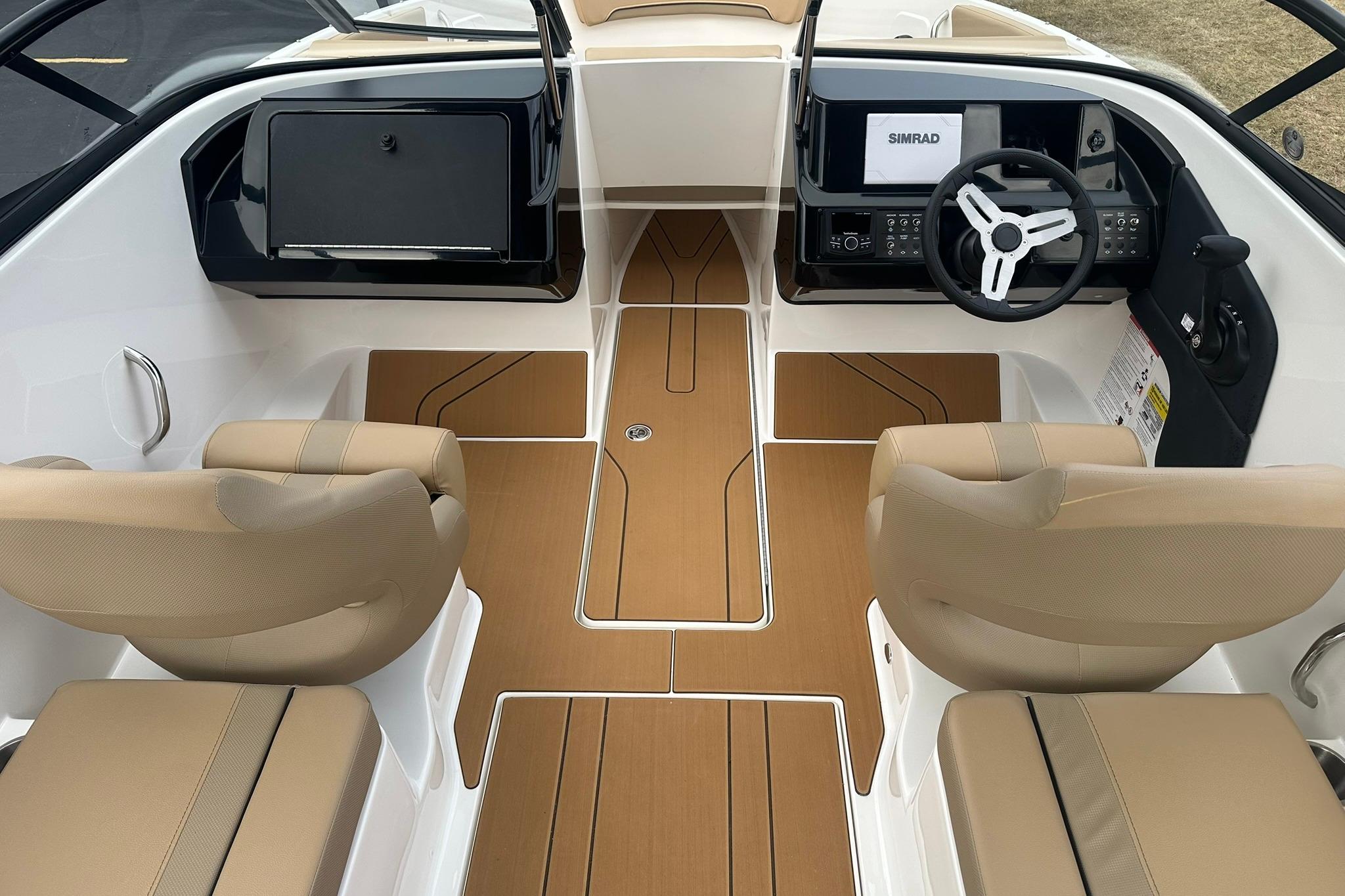 2026 Bayliner V20 boat interior with beige seats and modern dashboard.
