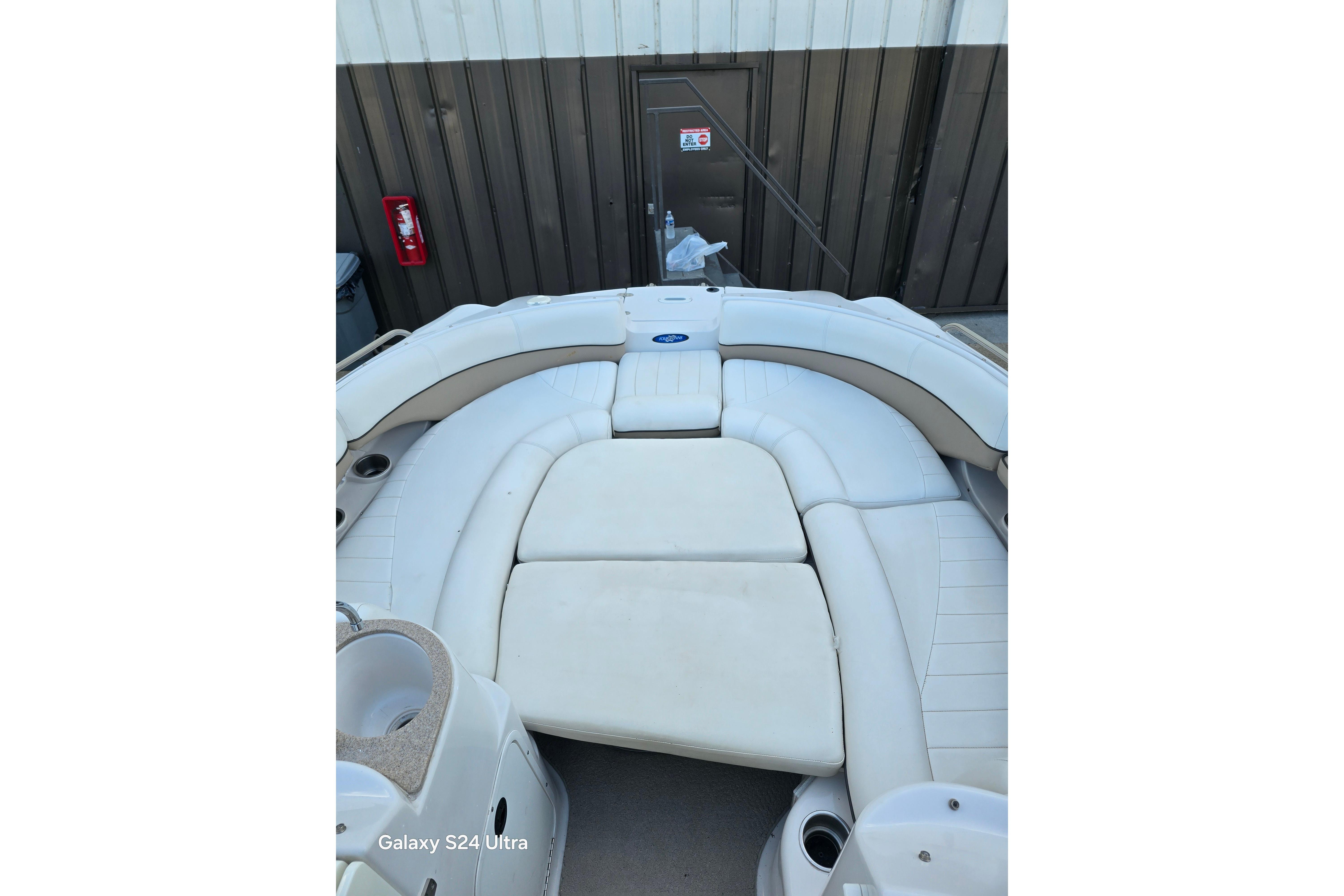 2006 Four Winns 244 Funship boat interior with white cushioned seating.
