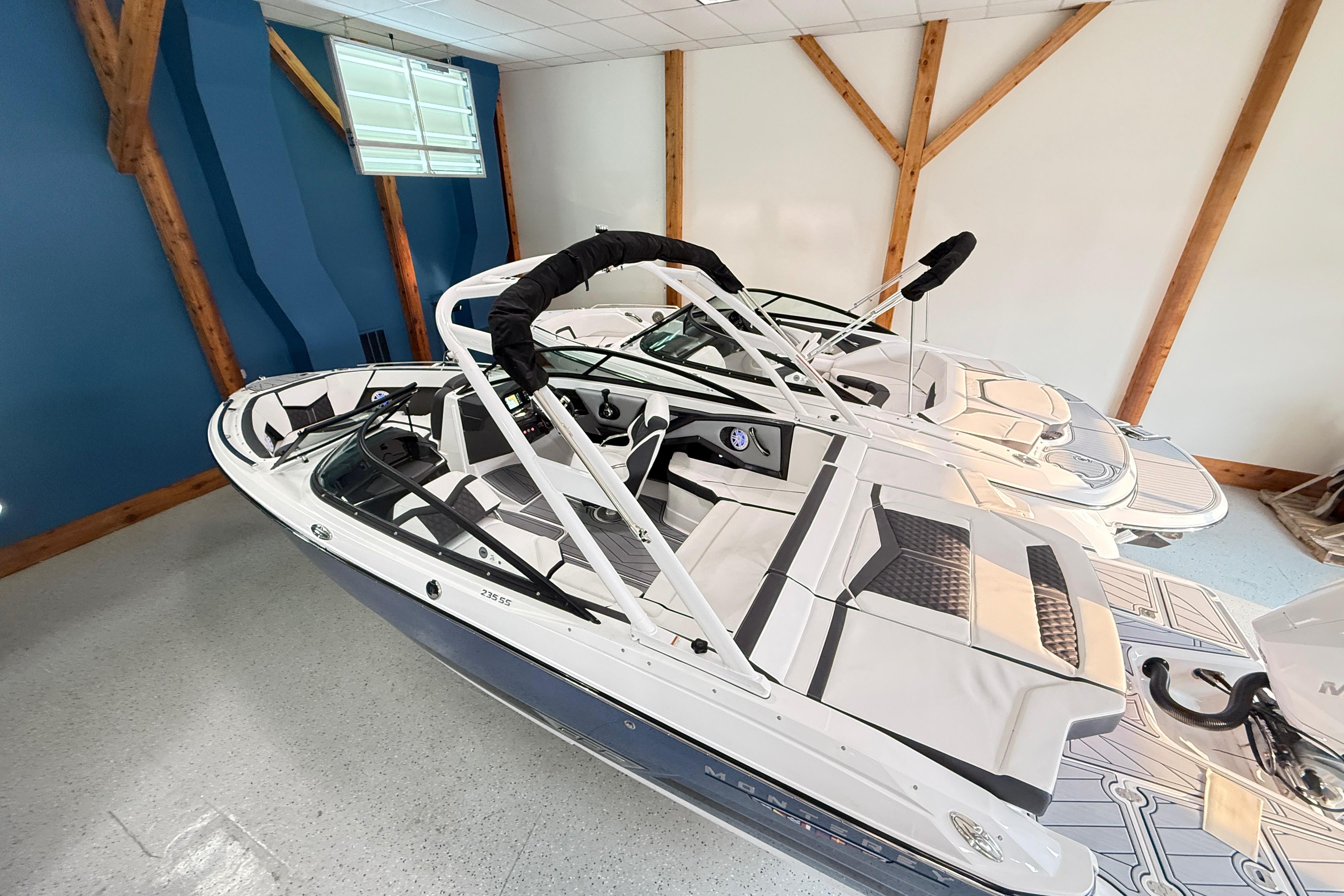 2025 Monterey 235SS Super Sport boat in showroom, featuring sleek design and modern interior.