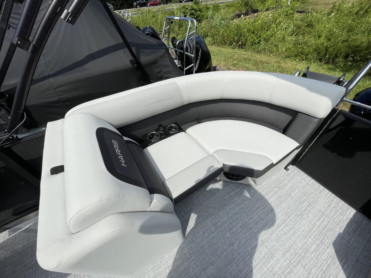 Luxurious seating on 2026 Harris Cruiser 230 boat with cup holders and sleek design.