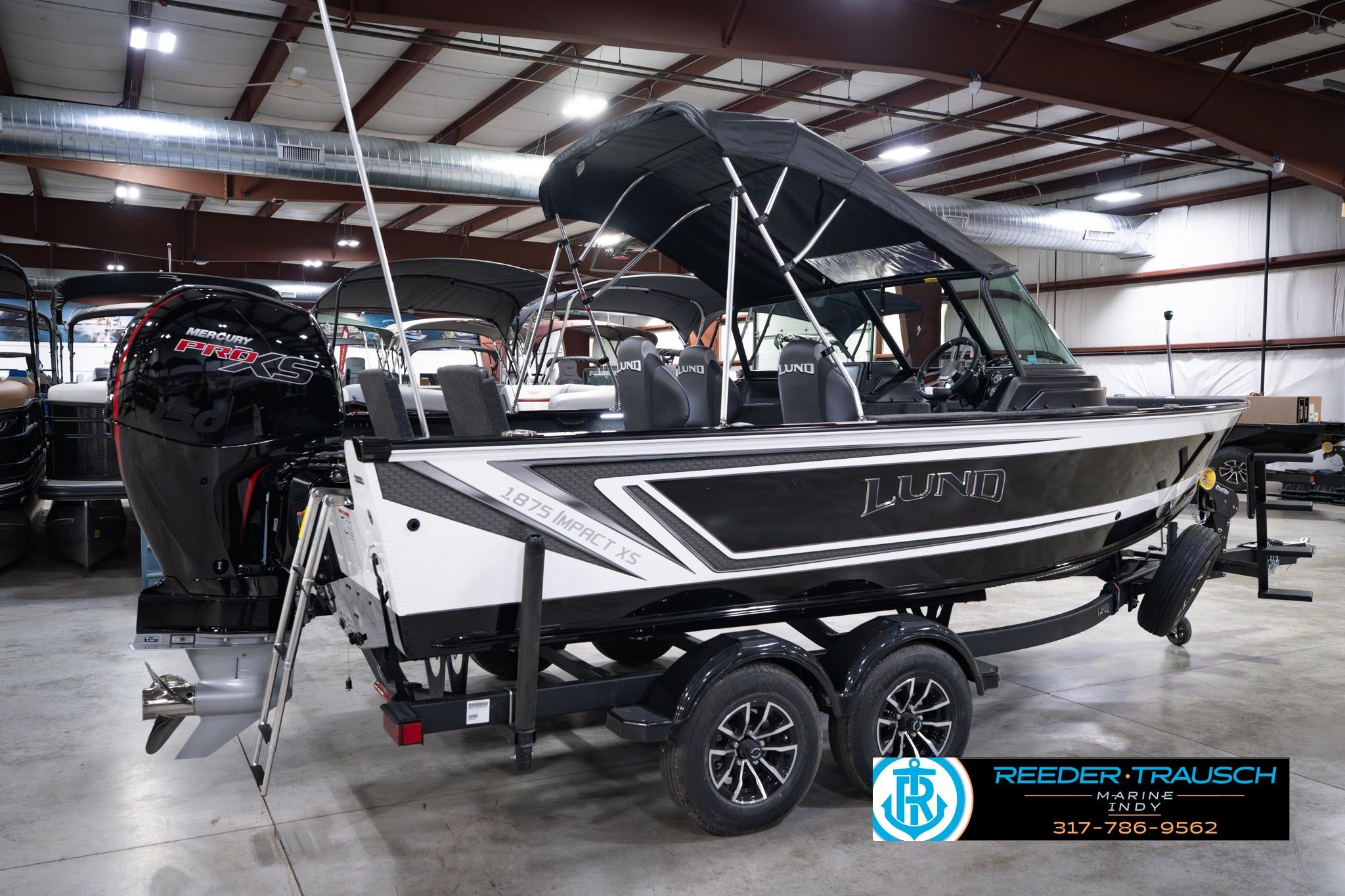 2026 Lund 1875 Impact XS SS boat with Mercury Pro XS engine in showroom.