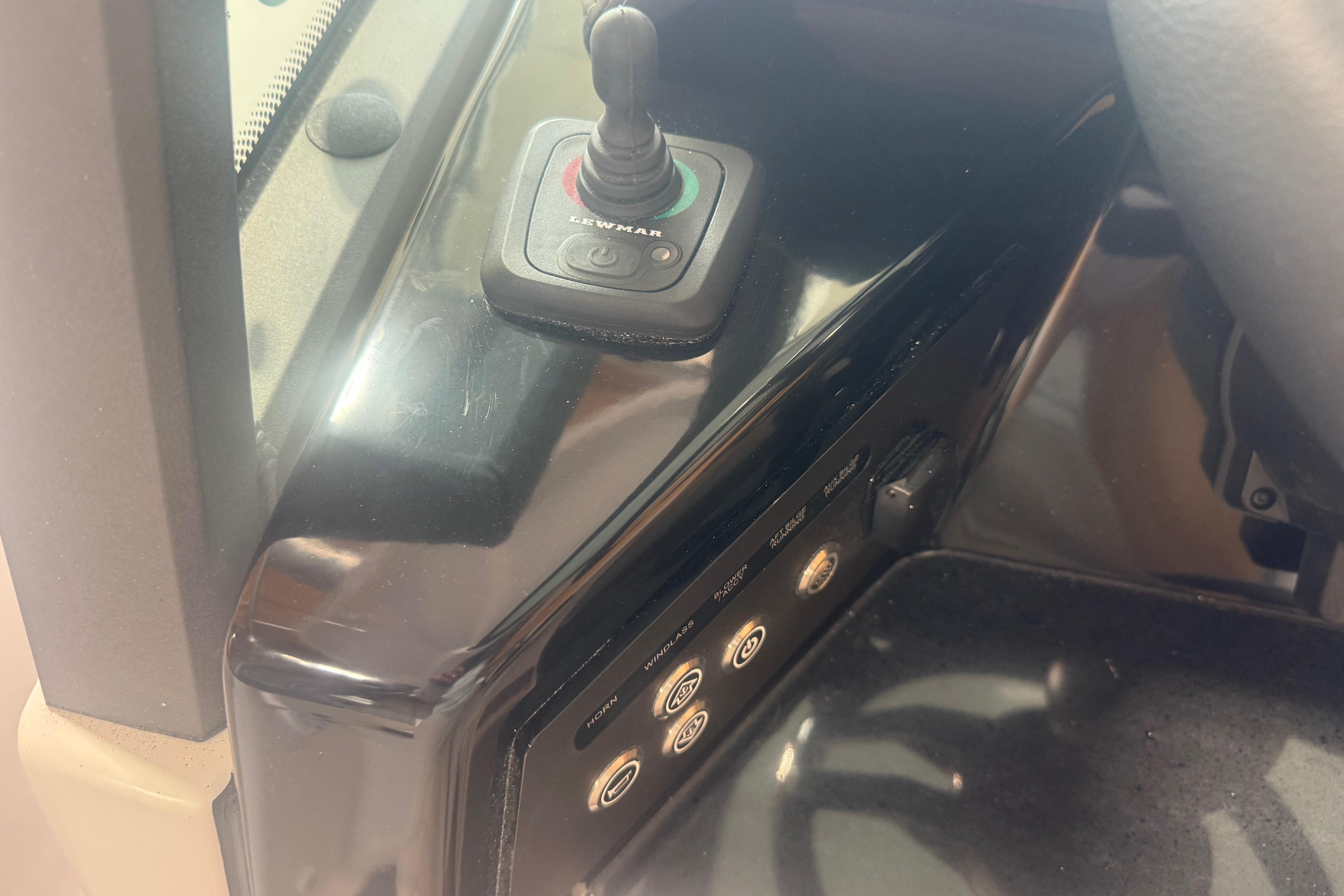 Control panel of 2027 Monterey Elite 27 SD boat with joystick and buttons.