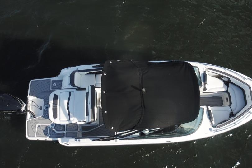 2022 Monterey 255SS Super Sport boat, aerial view, on dark water.
