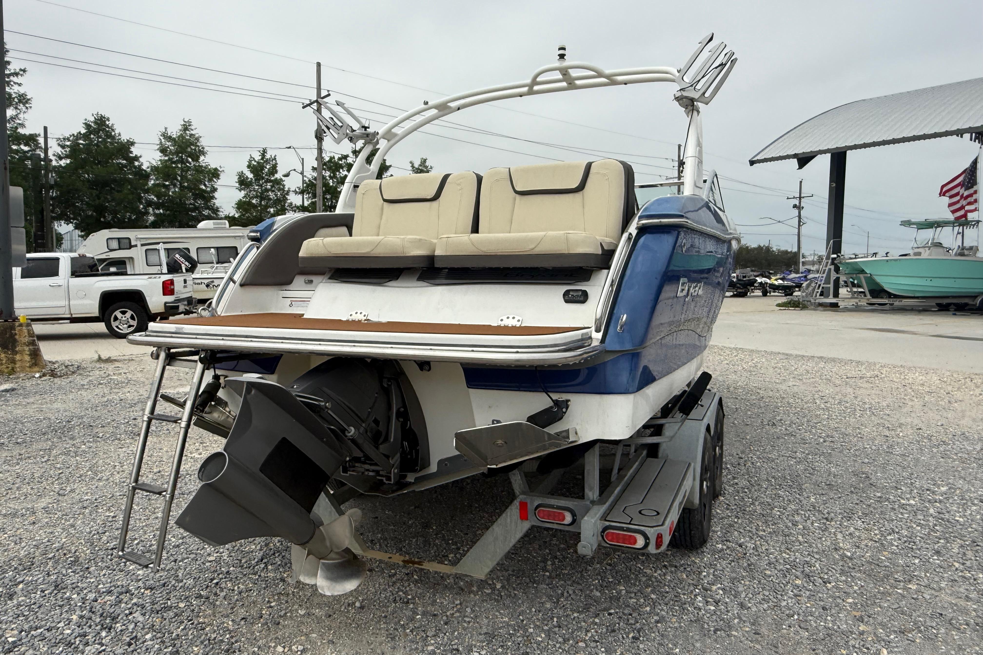 2018 Bryant Calandra boat on trailer, rear view, parked outdoors.