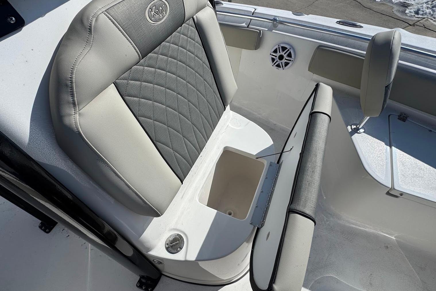 2026 Key West 219 FS boat seat with storage compartment, featuring gray and white upholstery.