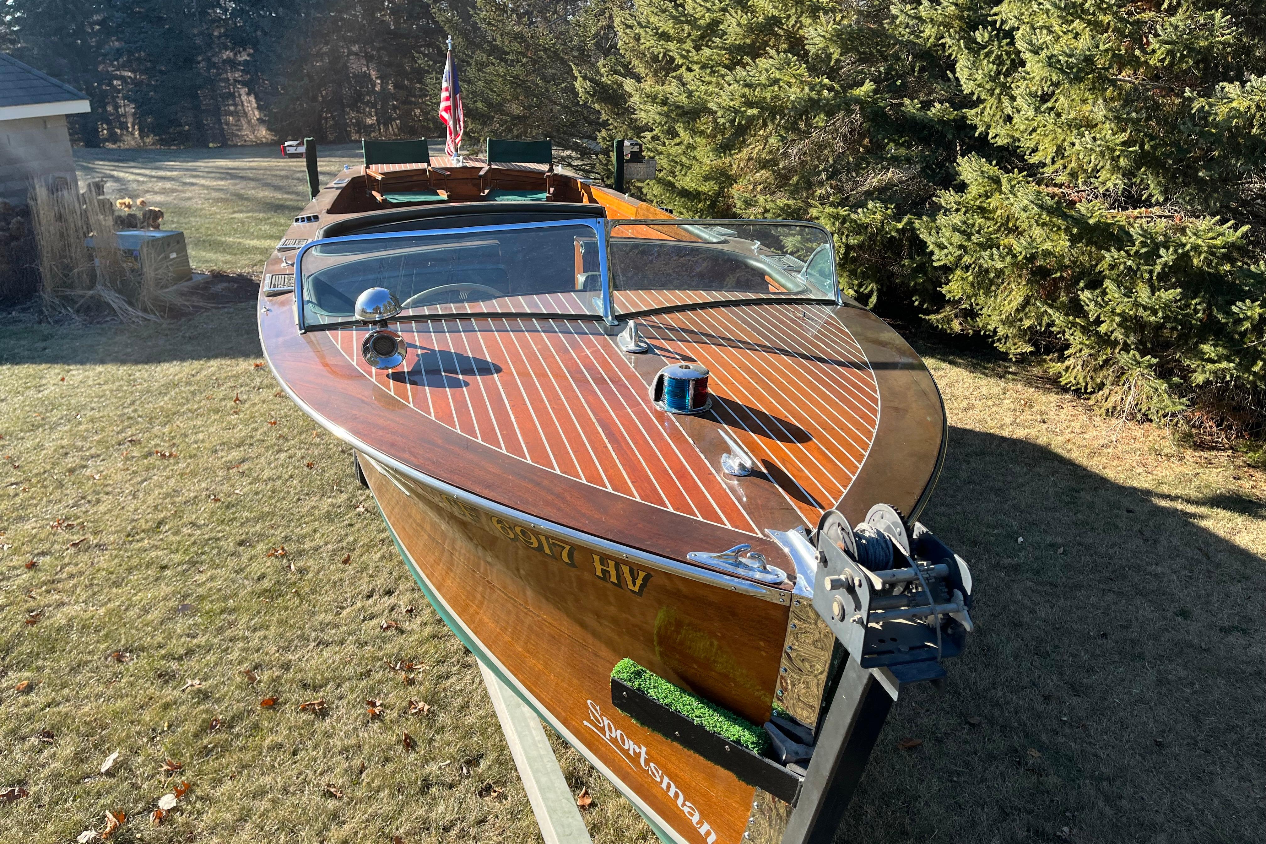 1938 Chris-Craft 28 Sportsman wooden boat on display in a grassy area.