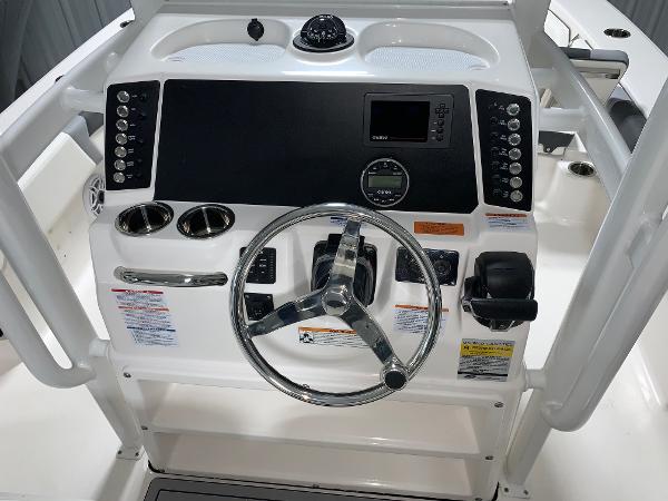 2024 Robalo 246 Cayman boat dashboard with steering wheel and control panel.