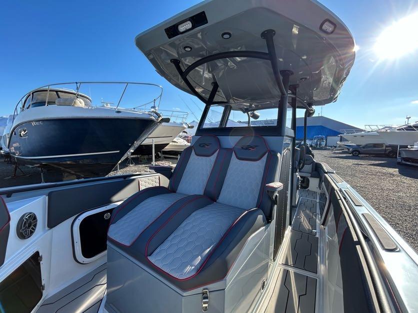 2024 Glasstream 32 GSX boat with modern seating and sleek design in a marina.
