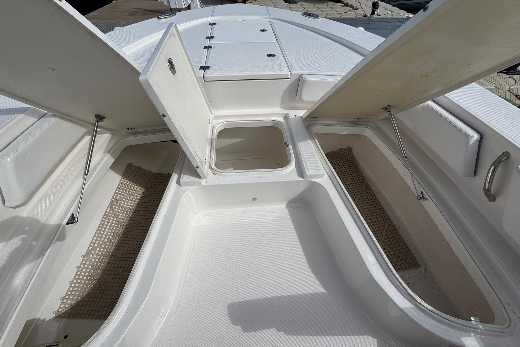 2021 Robalo 246 Cayman boat storage compartments open, showcasing spacious interior design.