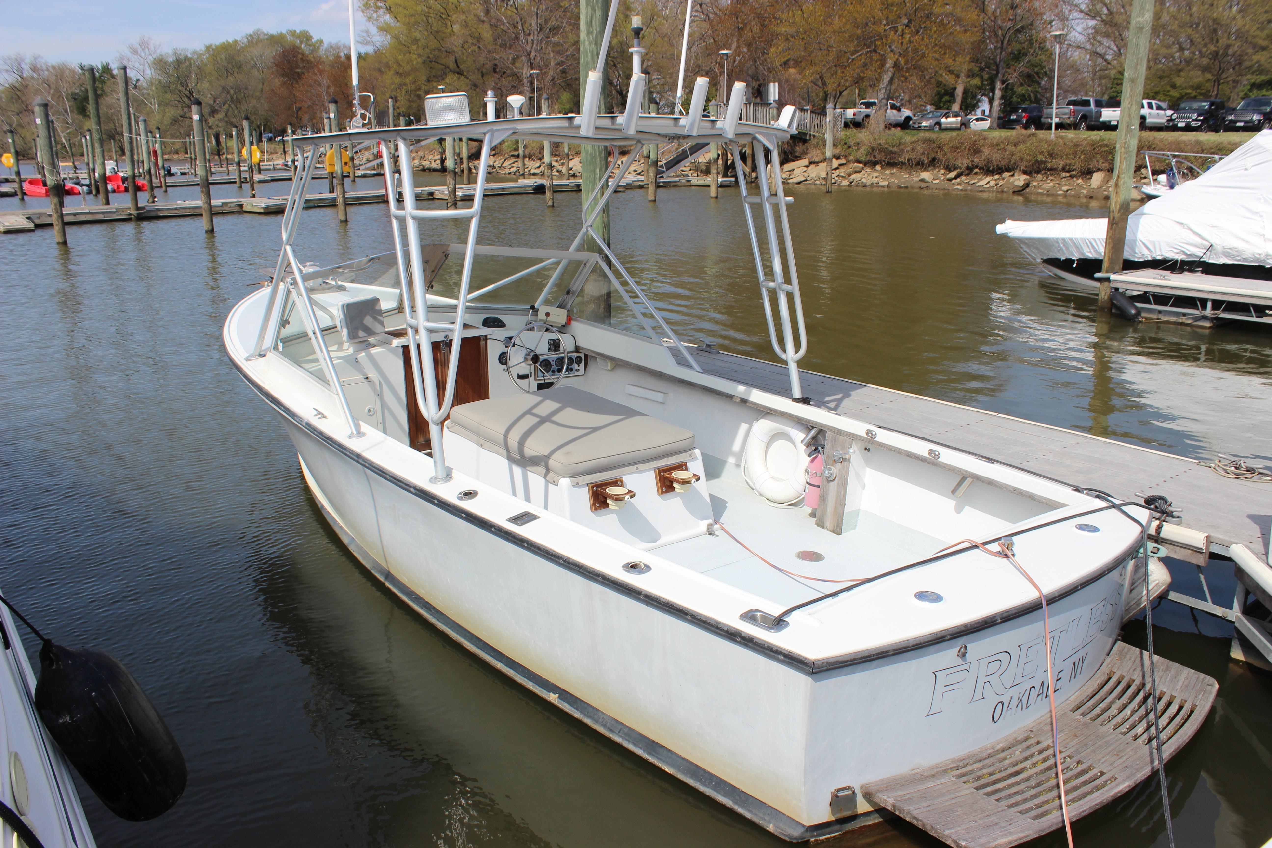 1979 Tripp Angler 22 Flush Deck Cuddy boat docked at marina.