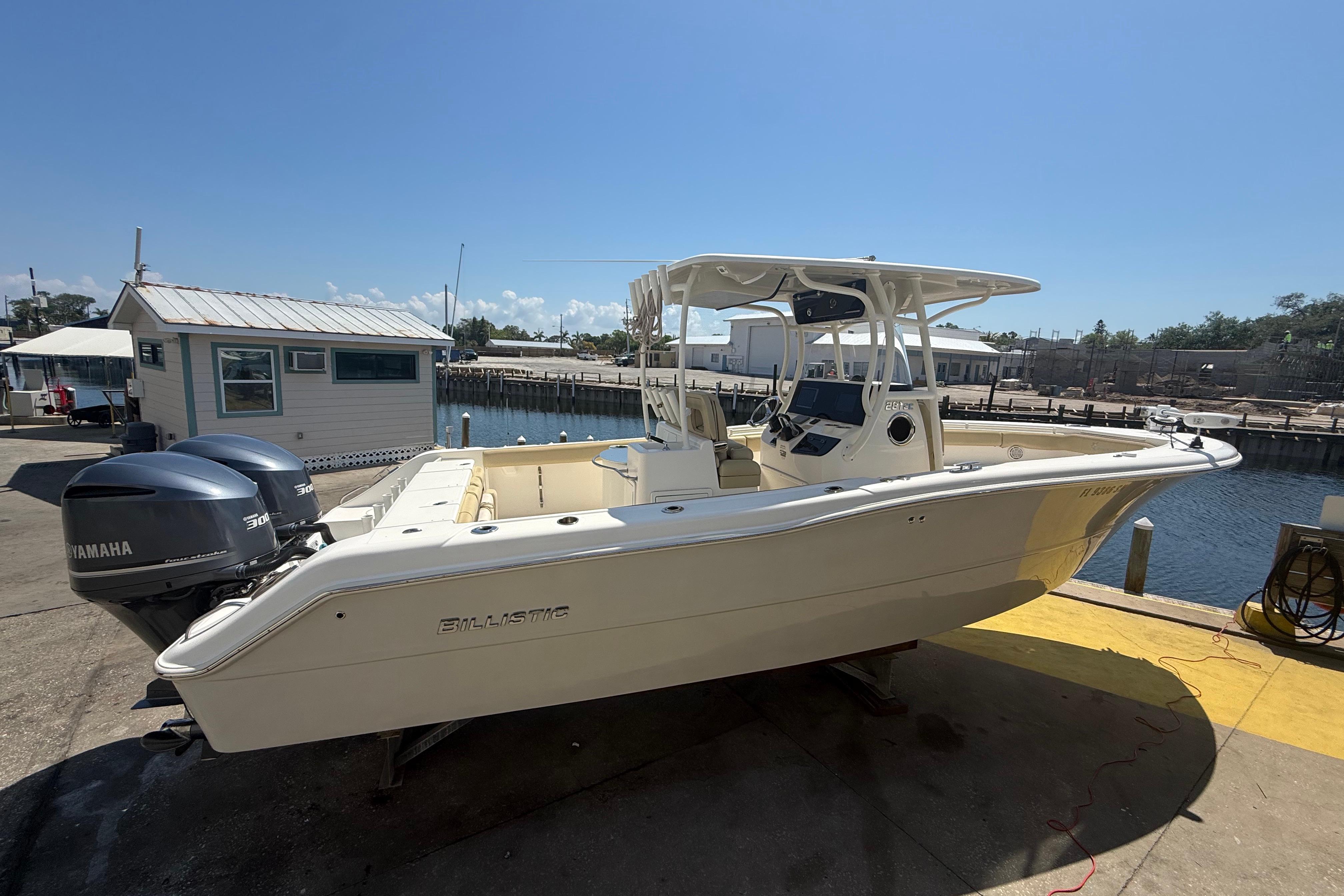 2019 Key West Billistic 281 Center Console boat docked with twin Yamaha engines.
