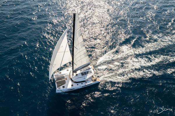 Aerial view of 2025 Nautitech 44 Open catamaran sailing on open sea.