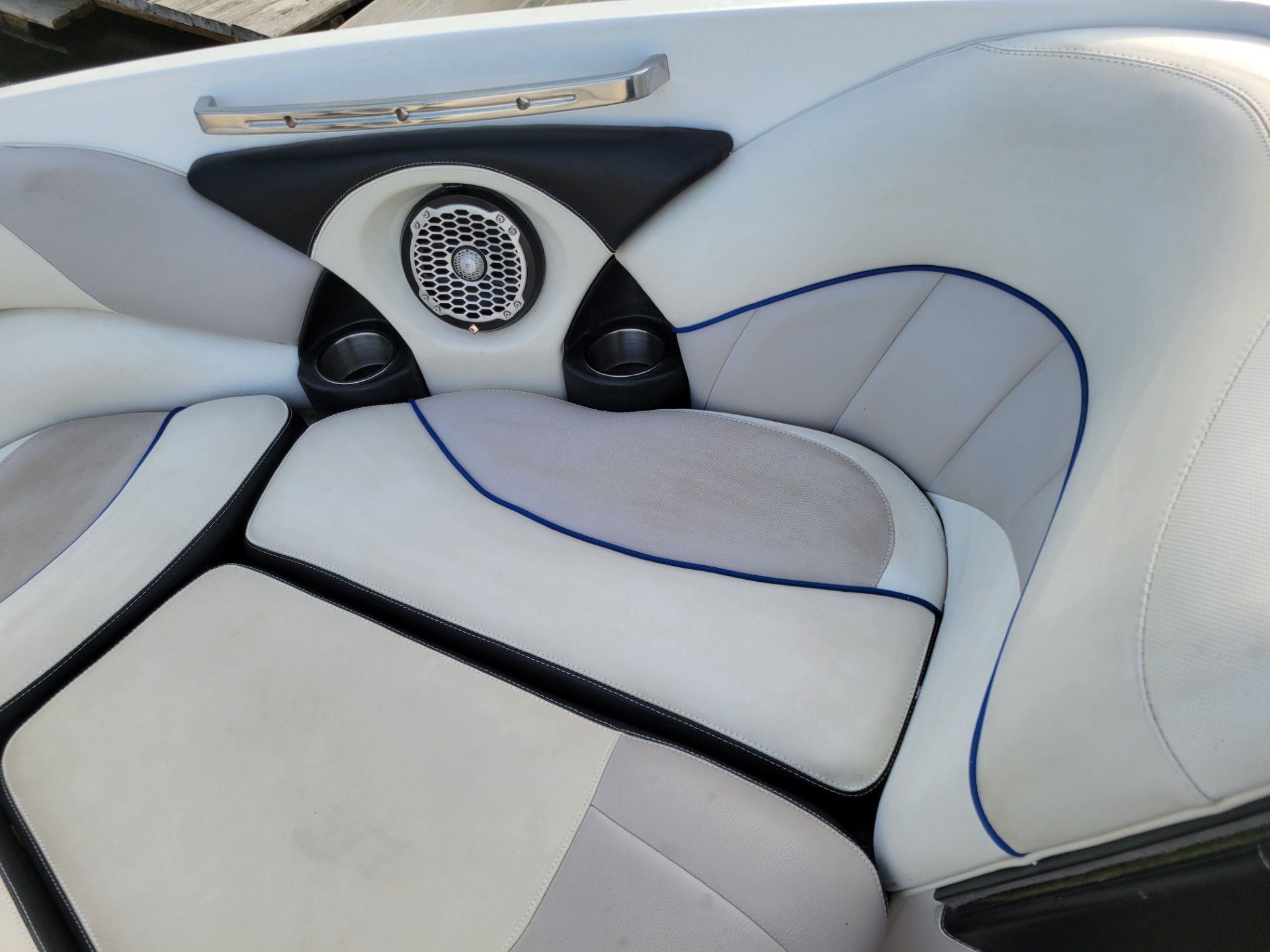 Interior of a Malibu Wakesetter 247 LSV with white upholstery and speaker.