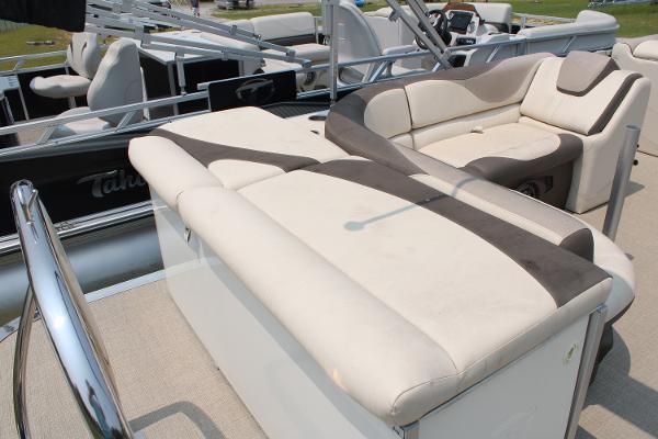 2021 Tahoe LTZ Cruise boat with beige and brown seating, docked outdoors.