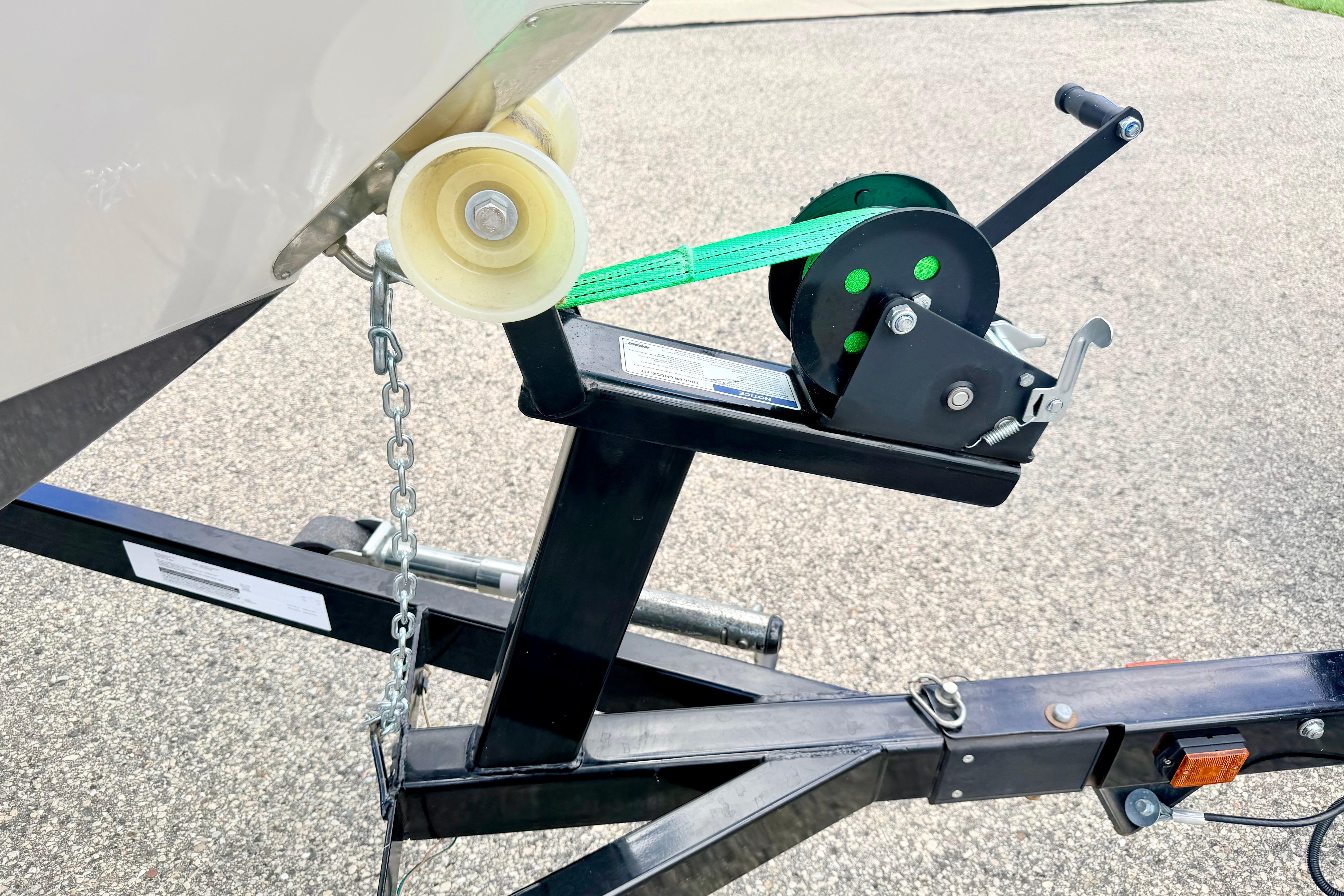 Trailer winch system for 2018 Glastron GT 185 boat, featuring a sturdy chain and strap.
