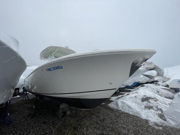 2023 Sailfish 290 CC boat on gravel, covered for storage.