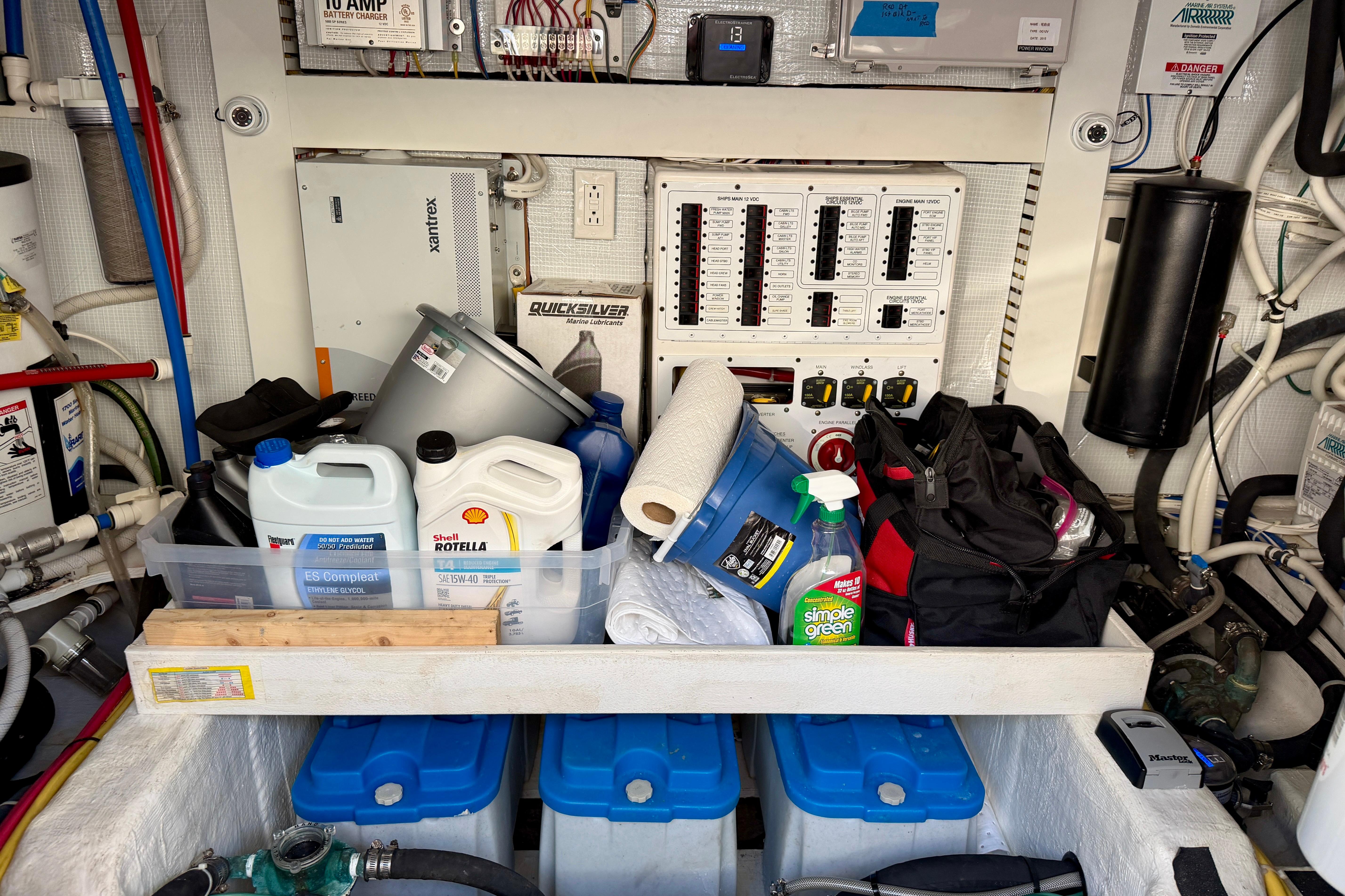Engine room of 2016 Sabre 48 Salon Express with maintenance supplies and control panels.
