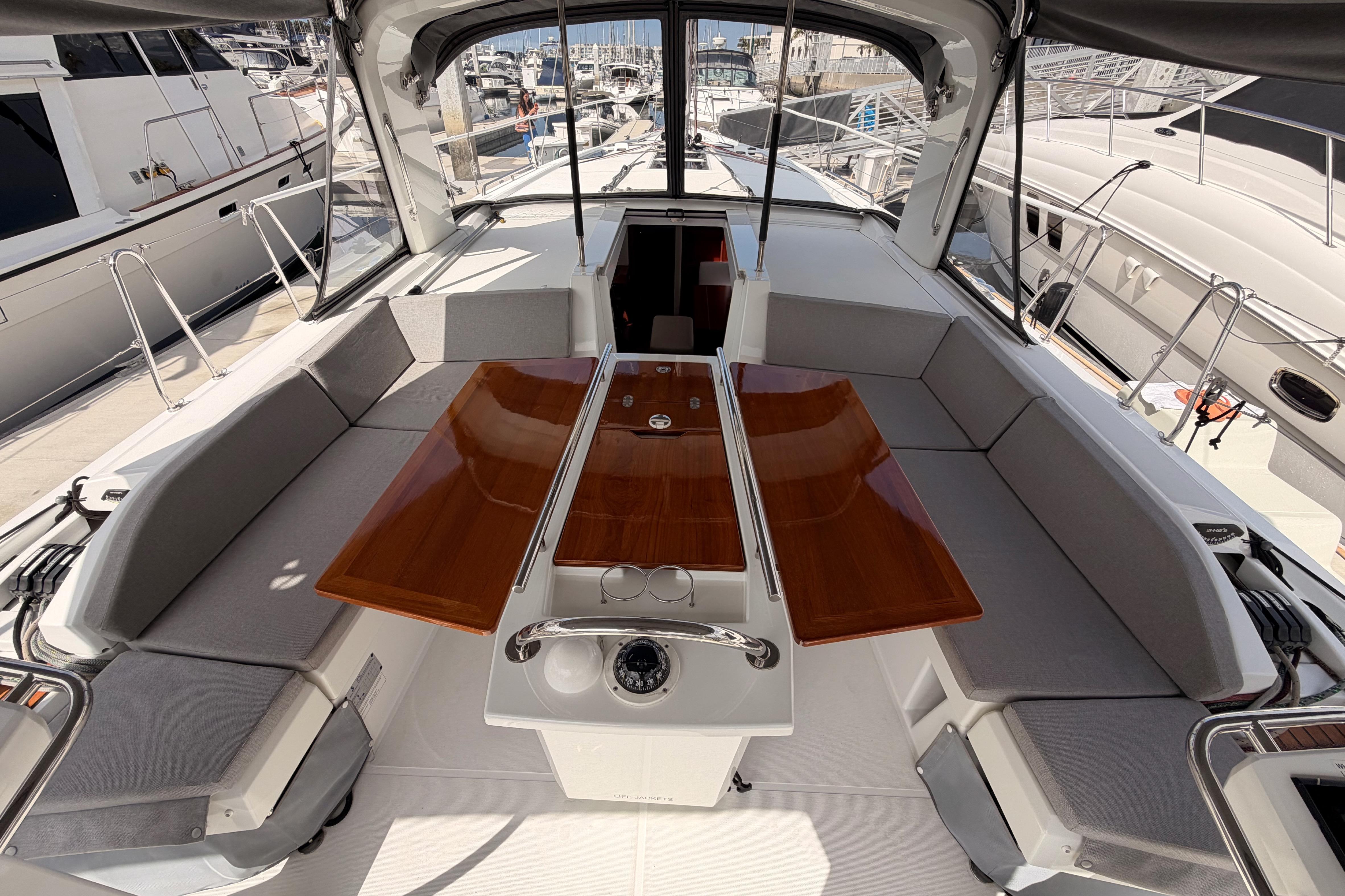 2020 Beneteau Oceanis 46.1 yacht cockpit with seating and wooden table.
