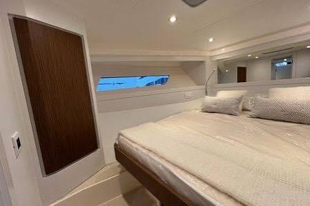 Luxurious interior cabin of 2023 Itama 45RS yacht with elegant bedding.