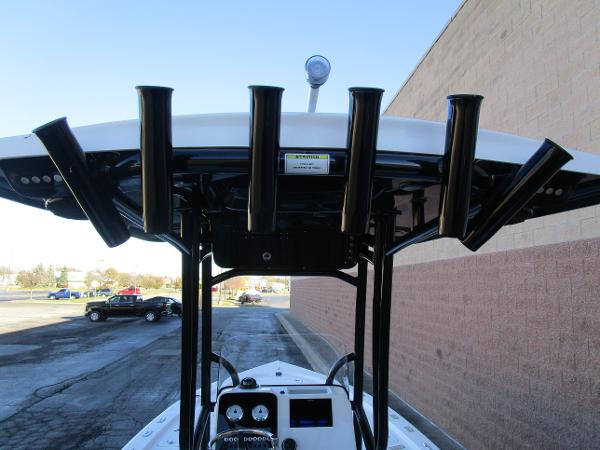 2025 Sea Pro 230 Bay boat with T-top and rod holders in parking lot.