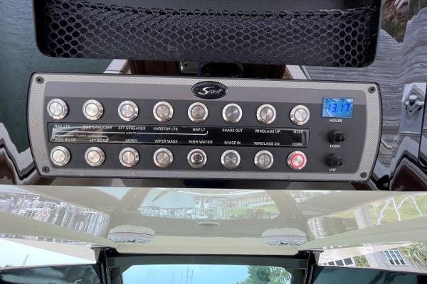 Control panel of a 2020 Scout 420 LXF boat with various switches and digital display.