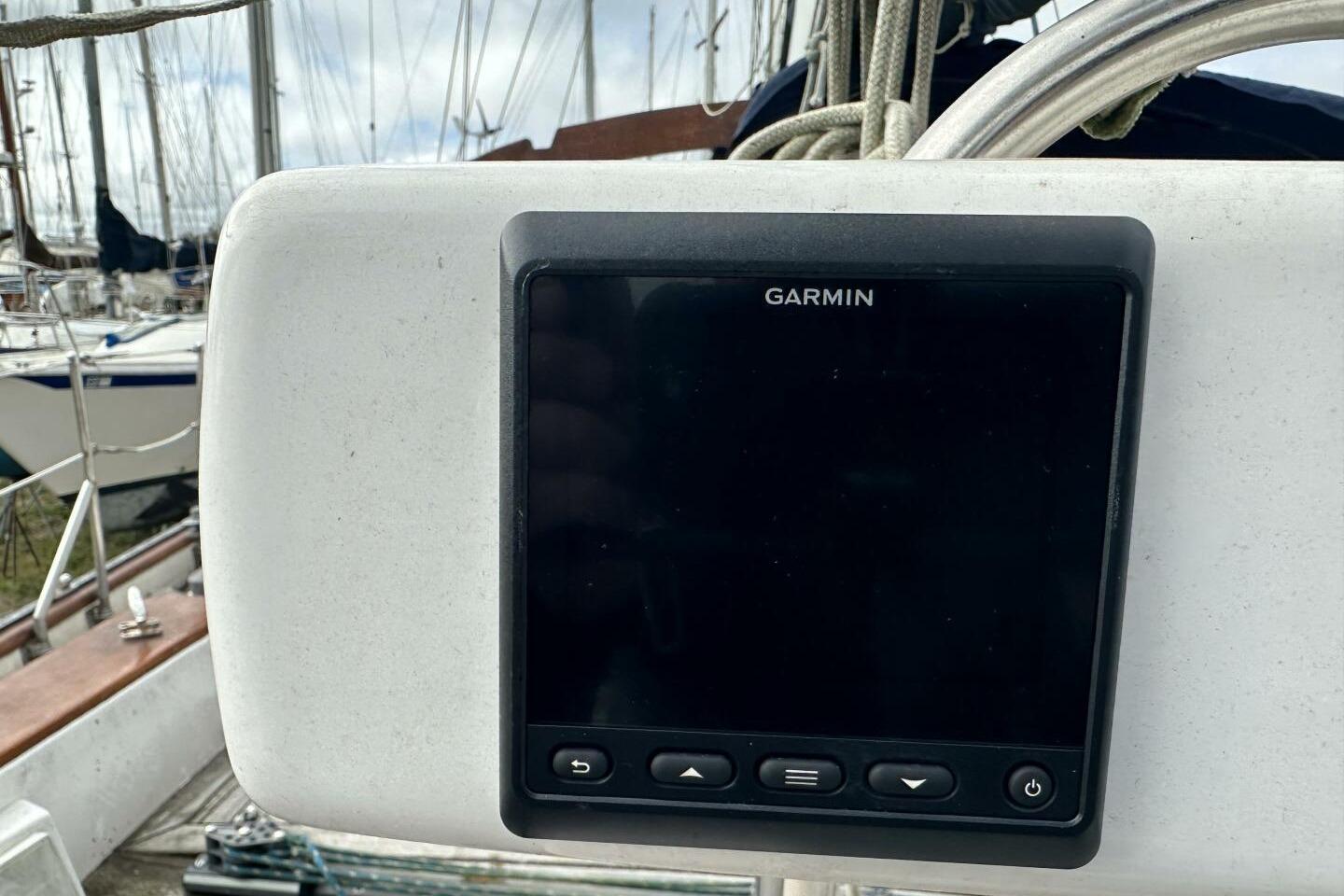 Garmin navigation device on 1986 Pan-Oceanic 46 sailboat, docked with other boats.