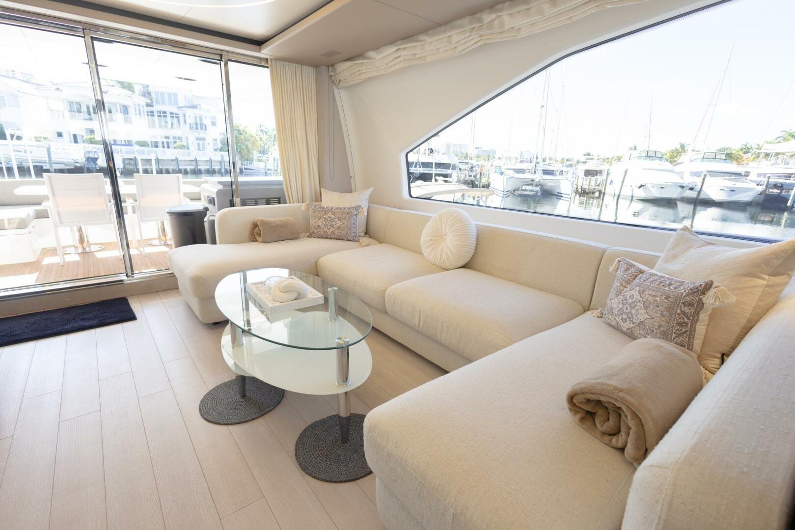 Luxurious interior of 2021 Azimut Fly 72 yacht with elegant seating and marina view.